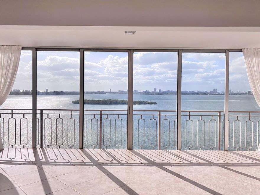 Breathtaking Biscayne Bay views from every window, where sparkling waters meet endless sky and natural light fills the space. Located within a gated waterfront community, this spacious 2-bedroom, 2-bath corner residence offers 1,408 square feet of comfortable living with sweeping views of Biscayne Bay and North Miami. The light-filled layout features an enclosed balcony, tile flooring throughout the main living areas, and carpeted bedrooms. A rare corner unit offering privacy, water views.