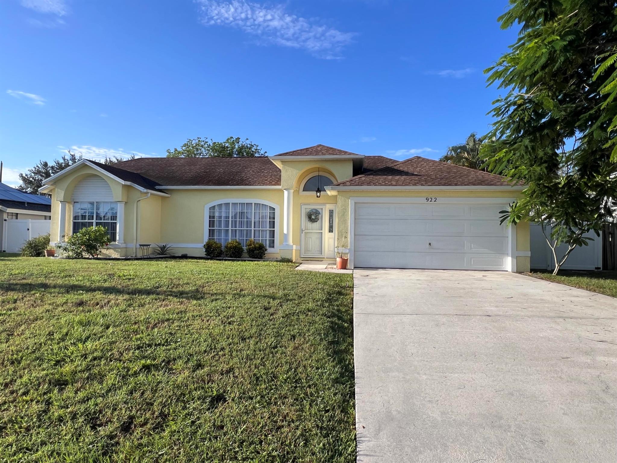 Welcome to this MOVE-IN ready, cherished one-owner home, nestled in a quaint neighborhood where neighbors wave, children play, & dogs are happily strolled. Just a block from the elementary school, nearby churches, and local shops w/ pizza, ice cream, and more. Inside, cathedral ceilings, a central open kitchen w/ 2 pantries, spacious split floor plan create a bright, open feel w/ 2 living areas (one with potential for a 4th bedroom). The roomy master suite features a walk-in closet, garden tub, & separate shower. Recent updates include underground electric by FPL, brand-new HVAC ('25), newer water heater ('23), Samsung stainless steel appliances with brand-new refrigerator & microwave, and a new washer. The 2011 roof adds peace of mind. Step outside to a lengthy tiled screen-in porch that