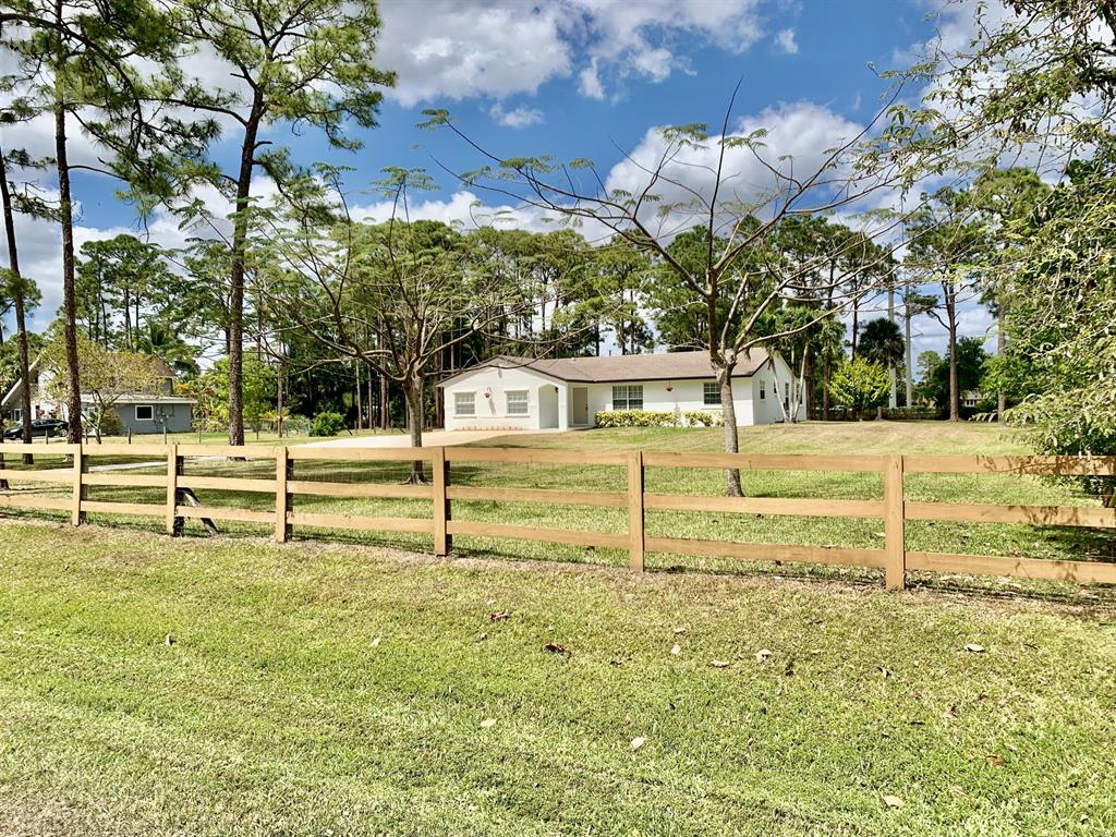 Immaculate 4-bedroom home fully fenced & gated, on high & dry 1.25-acre lot, without pond. Enjoy quiet, stress-free living, in a great location and without an HOA. Home is beautifully updated throughout including window treatments. The large indoor laundry has 96'' counter/folding space and plenty of cabinets. The large primary suite boasts three closets and a view of the expansive back yard. Enjoy outdoor living on the back covered patio, an extension of the home. An extra-large 4th bedroom with separate entry & HVAC is perfect for in-law suite, office, or even rental space. Sprinkler system is on separate well. Wired workshop provides covered parking, plus RV / boat pad. The very large driveway allows parking of multiple vehicles. This fantastic move in ready home awaits you.