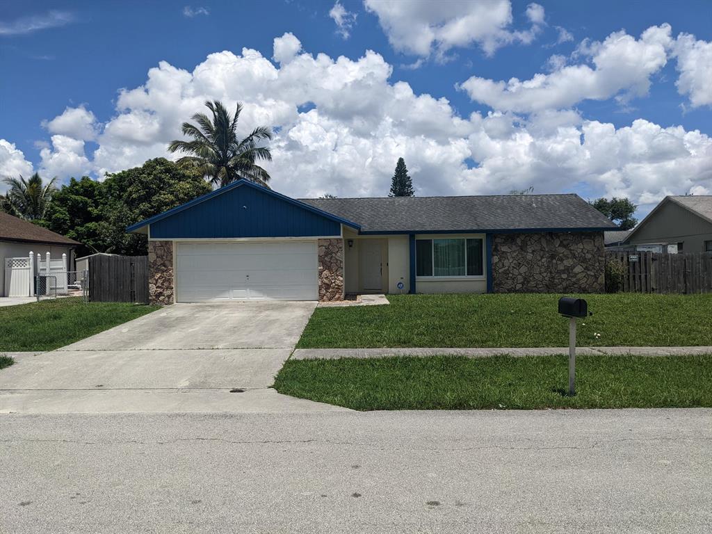 This Beautiful Royal Palm Beach home features 3 bedrooms, 2 baths, and a 2 car garage with a fenced yard and swimming pool. This home is available immediately. New impact windows in all glass openings, large living room window, lots of windows and lighting throughout the home. Porcelain tiles in living rooms and kitchen and attractive mid-height baseboards. Granite counter, stainless steel appliances, decorative lighting, fans, as well as recessed lighting. Renovated master bathroom with glass shower doors and floating mirrors. The home features a large master bedroom for a King size bed with a walk in closet. This home features a large patio for entertaining, a patio slider, and a pool safety fence. No HOA / No approval or restrictions. Can close quickly.