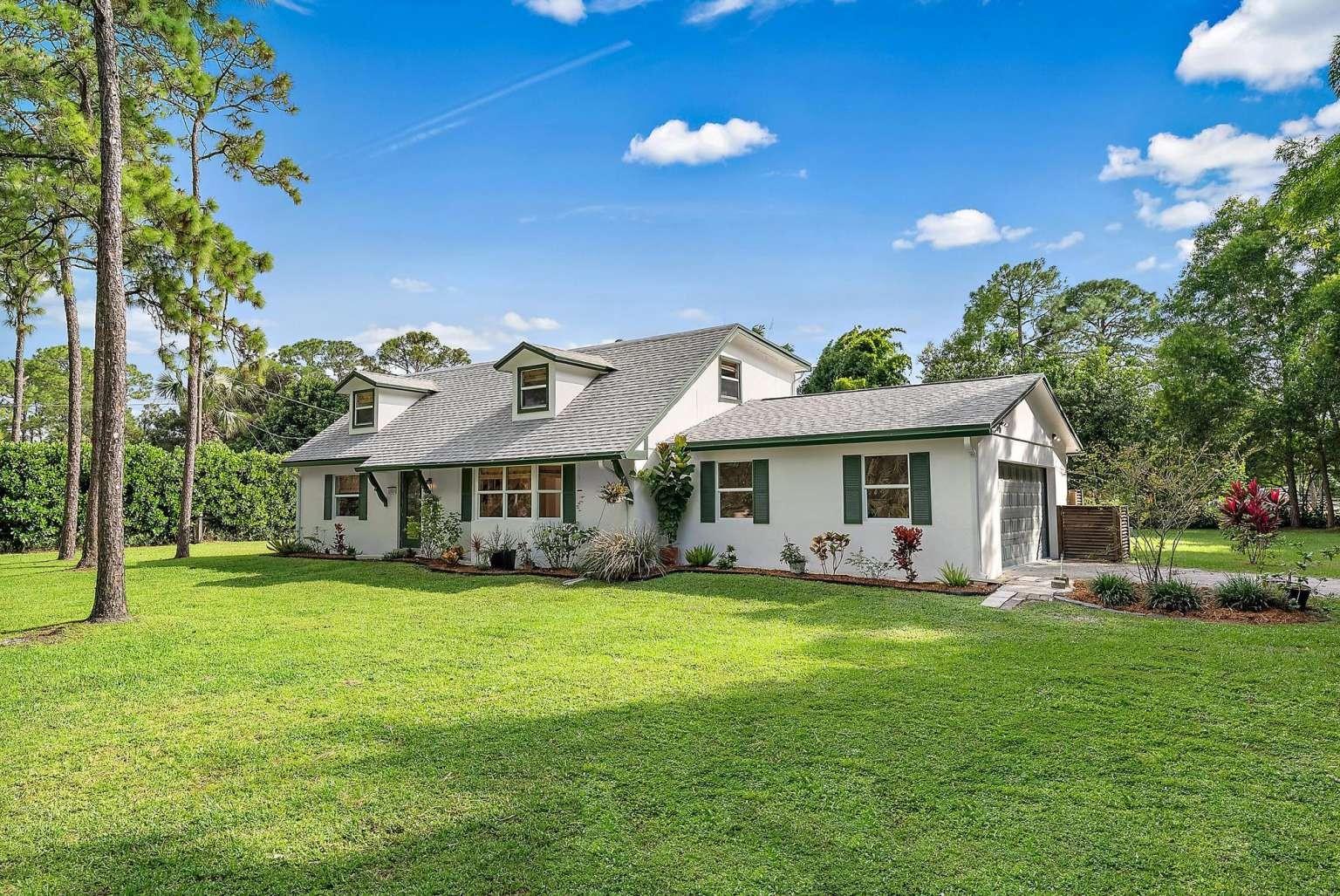 Experience peaceful Florida living on 1.25 private acres in this beautifully updated home that blends modern comfort with lush outdoor spaces. Inside, you’ll find a completely refreshed interior with new tile flooring, fresh paint, updated wall textures, recessed lighting, upgraded electrical, and modern ceiling fans. The kitchen features custom cabinetry, new appliances, and tile floors that flow seamlessly into the open dining and living areas. Bedrooms include soft new carpeting for a cozy touch. Built for comfort and peace of mind, the home offers impact windows throughout, a new impact front door, CBS construction on the first floor with hardie-board siding above, and a new sliding door with hurricane shutters.