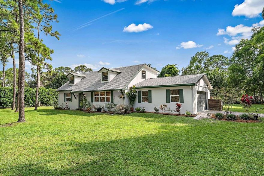 Experience peaceful Florida living on 1.25 private acres in this beautifully updated home that blends modern comfort with lush outdoor spaces. Inside, you’ll find a completely refreshed interior with new tile flooring, fresh paint, updated wall textures, recessed lighting, upgraded electrical, and modern ceiling fans. The kitchen features custom cabinetry, new appliances, and tile floors that flow seamlessly into the open dining and living areas. Bedrooms include soft new carpeting for a cozy touch. Built for comfort and peace of mind, the home offers impact windows throughout, a new impact front door, CBS construction on the first floor with hardie-board siding above, and a new sliding door with hurricane shutters.