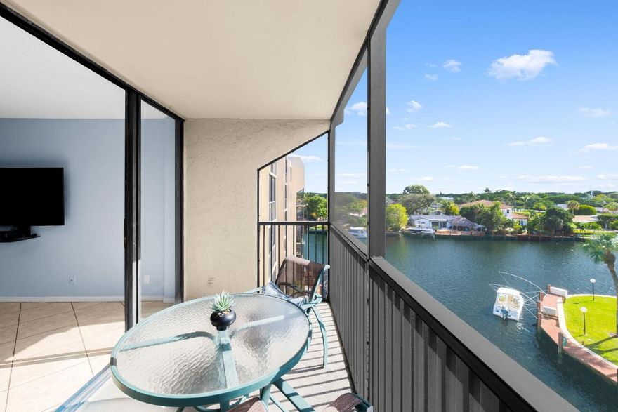 Welcome to waterfront living in Boca Bayou, where everyday begins with sparkling sunrise views and ends with breathtaking sunsets over the Hillsboro Canal. This spacious 2 bedroom, 2 bath corner unit is located in one of the most desirable buildings in Boca Bayou that allows in-unit washer/dryers.  This ''Deluxe'' unit offers additional square footage compared to a standard unit and an eat-in kitchen area.  Relax on the extended screened-in covered balcony and enjoy the views of the boats passing by.   Boca Bayou is also a great investment option, being one of the limited communities in Boca Raton that allows the owner to rent their unit immediately. Click here for more information: Boca Bayou is a premier 721-unit gated waterfront condominium community in the heart of downtown Boca Raton, set on 46 acres of beautifully landscaped grounds with waterways offering views of the Hillsboro Canal and direct access to the Intracoastal Waterway. Located less than two miles from the beach and minutes from Royal Palm Plaza and Mizner Park, residents enjoy close proximity to upscale shopping, dining, and entertainment. The community features resort-style amenities including five heated swimming pools, tennis and pickleball courts, two fitness centers, saunas, bocce and shuffleboard courts, pool houses, multiple natural gas grills, a putting green, and convenient car wash stations, all secured by a 24-hour manned gatehouse. Boaters benefit from private canals with docks available for rent when offered, creating a true luxury waterfront lifestyle in one of East Boca's most desirable addresses.