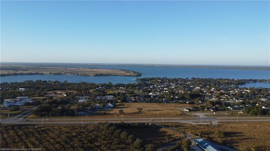 Over 10 acres of prime US Highway 27 frontage. Three existing buildings w/ total of 7874 sq ft, built as model homes for neighboring gated community, previously used as medical offices and maintained in good, clean condition, with 40 paved parking spaces as currently configured.  Upscale, gated Tomoka Heights community adjacent to the north and west. 1/5 mile highway frontage, opposite the expected Amazon Fulfillment Center. Dedicated highway crossover with deceleration lanes in both directions. Existing R3 zoning permits - among many other uses - medical and professional offices, single and multi-family housing, apartments, condos, hotels/motels and assisted living/nursing care. Seven additional acres zoned B3 available directly across the highway.