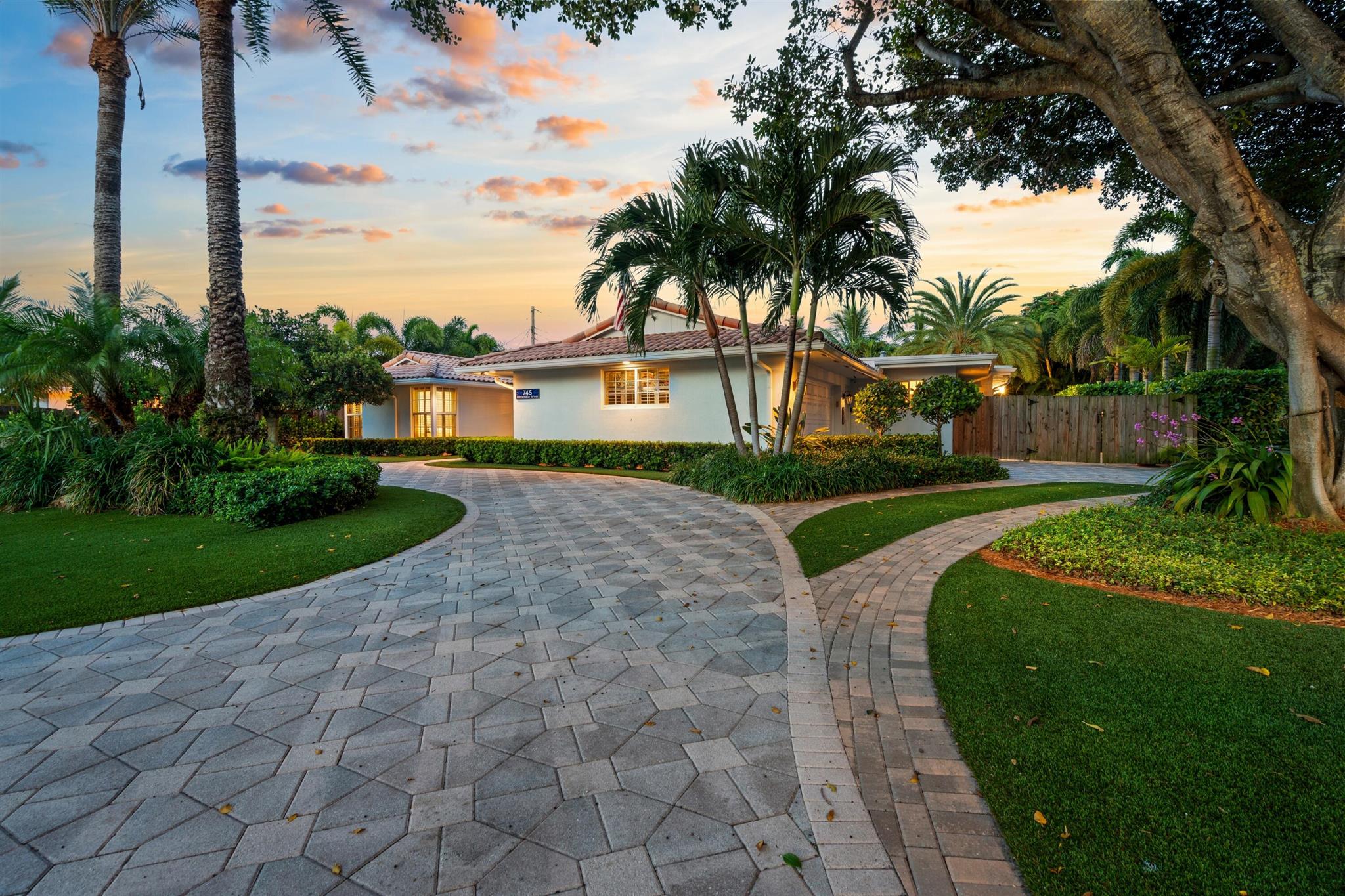 Blending West Indies charm with modern luxury, this renovated residence, with four bedrooms and 3,273+/- total square feet, conveys a relaxed casual elegance that emphasizes easy livability and care-free maintenance. Impact-glass sliding windows and doors from all main rooms offer serene pool and garden views, designed in an open flowing layout that meets every need for gracious entertaining. The temperature-controlled 200-bottle wine room, perfectly positioned next to the dining area, is a connoisseur's delight, while the spacious great room adjoins the gourmet kitchen appointed with high-end Miele appliances. Imported Italian wide plank wood style porcelain tile flooring throughout and Plantation shutters in the living areas and bedrooms lend a coastal ambience.