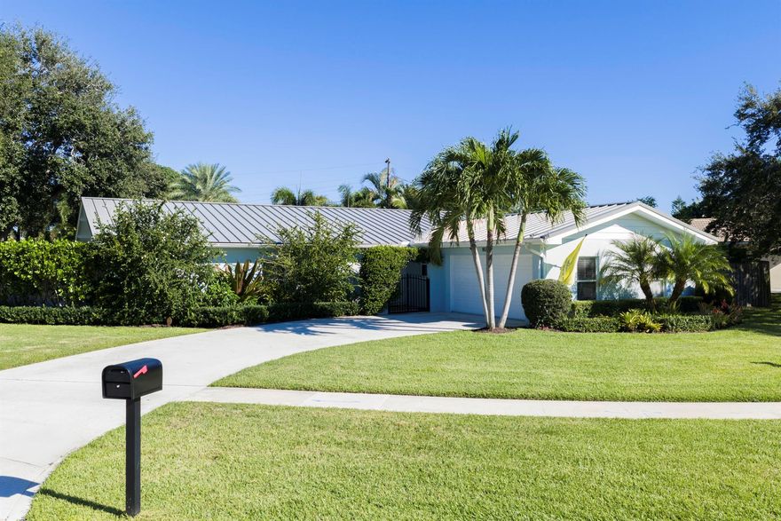 Effortless Ranch-Style Living Meets Resort-Inspired Outdoor Luxury. Welcome to this beautifully appointed ranch-style residence in the heart of North Palm Beach where timeless design, comfort, and a vibrant outdoor lifestyle come together seamlessly. This ranch style home is made for entertaining, with an open-concept layout that flows effortlessly to an expansive sun deck and salt-chlorinated heated pool featuring two serene water features. Framed by lush Calusa hedges, bamboo, and fully fenced for total privacy, the backyard feels like a private resort -- perfect for lounging, dining, and gatherings that stretch into the evening. An oversized lanai and multiple ceiling fans keep the outdoor space comfortable year-round, offering the ideal backdrop for Florida living.