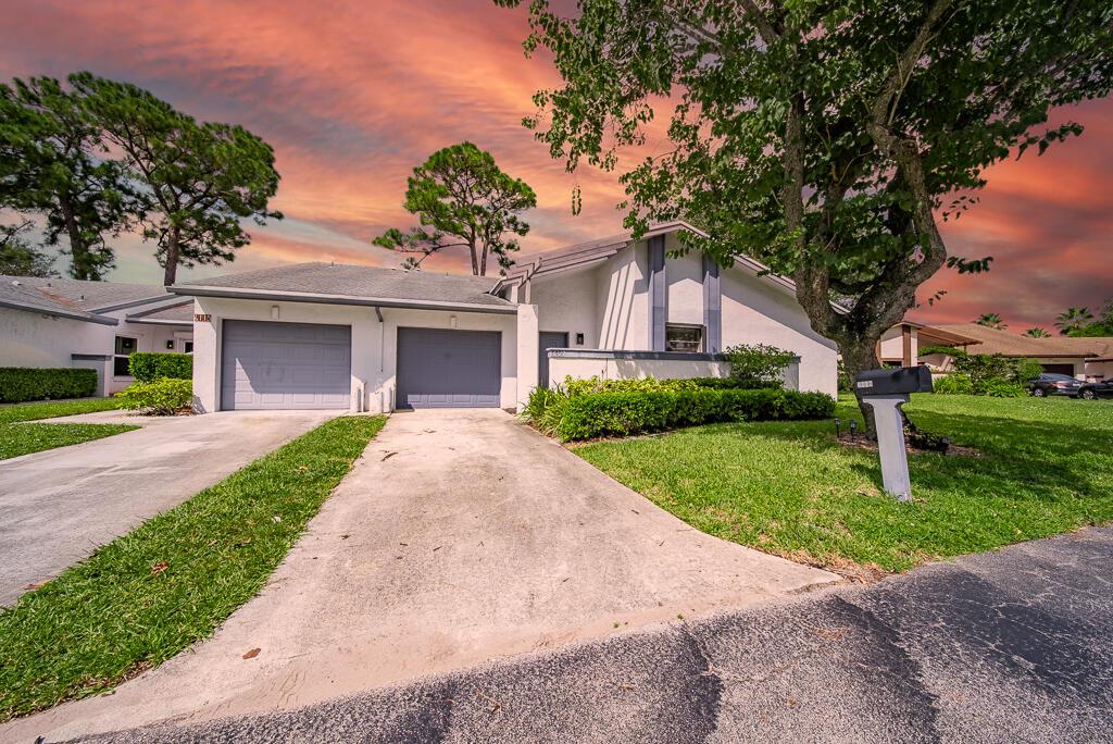 ***55+ community! This updated corner villa features 2 bedrooms, 2 bathrooms, and a 1-car garage, all within 1,188 square feet of move-in-ready living space. As you enter, you're greeted by high ceilings and an open layout with neutral colors and laminate floors. The dining area flows into a spacious kitchen, equipped with white cabinetry illuminated by under-cabinet lighting, granite countertops with a waterfall feature, and a cozy breakfast nook. The master bedroom offers patio access through sliders, a walk-in closet, and an ensuite with a step-in shower. The laundry area is in the garage, complete with a washer and dryer.