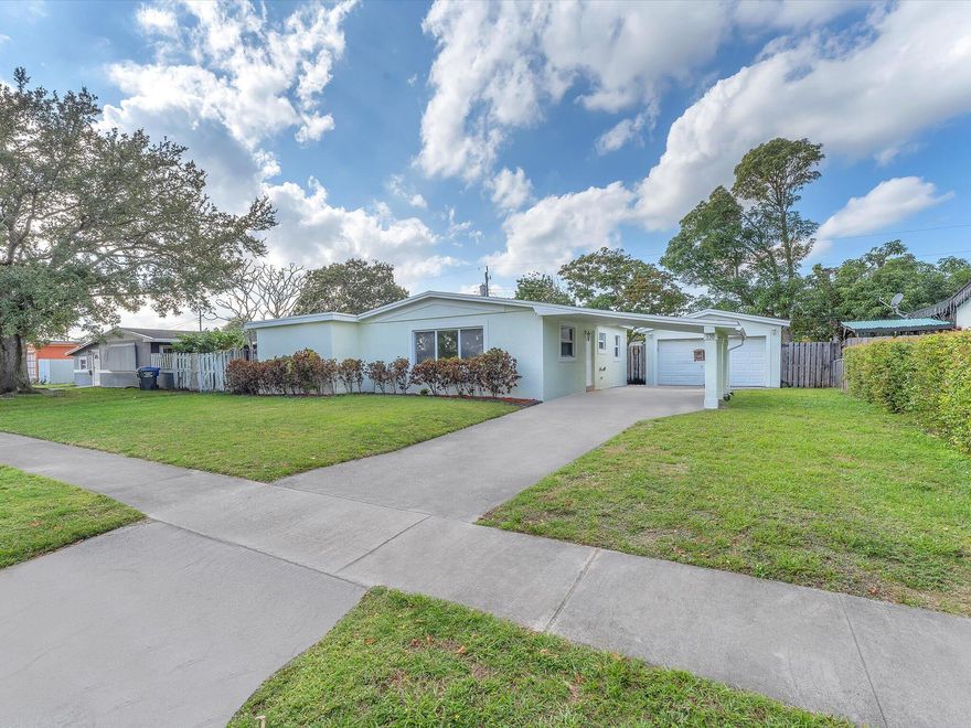 Under $500K with a detached two car garage and brand new roof in Hollywood. This move in ready home features 2 bedrooms, 2 bathrooms, and 1,245 sq ft of living space on a spacious 7,200+ sq ft lot. Inside you'll find new flooring throughout, an updated kitchen, and fresh interior paint, creating a bright modern feel.   The detached two car garage plus additional carport provides rare parking, storage, or workspace options in this price range. The oversized backyard offers room to relax, entertain, or create your ideal outdoor space. Conveniently located near shopping, dining, parks, and major highways. Homes with this combination of updates, garage space, and lot size are hard to find at this price point.