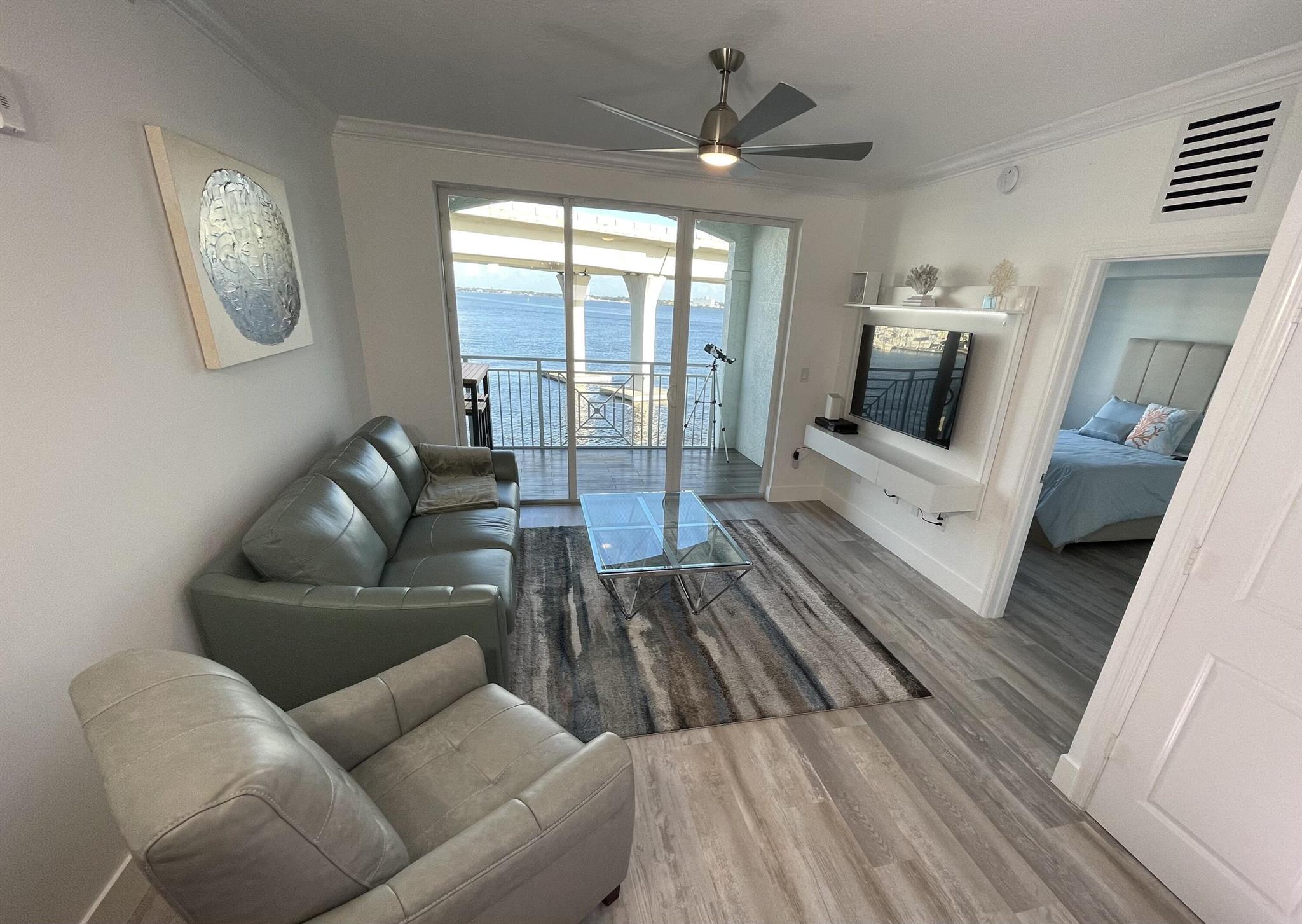 Waterfront Living at Its Finest! This stunning 2-bedroom, 2-bath condo offers breathtaking views of the St. Lucie River from your private balcony. Located on the 4th floor, this unit features a modern design with vinyl & tile flooring throughout, granite kitchen countertops, & washer/dryer for added convenience. The spacious master suite includes a walk-in shower, a soaking tub, & ample closet space, while the second bedroom is equally inviting. Water, Cable & Internet Included. Enjoy included resort-style amenities: Two heated pools, hot tub, sauna, fitnesscenter, clubhouse with planned social activities, poolside cafe & bar, TideHouse Restaurant on-site, Full-service marina with potential dockage foryachts up to 100'. All located just a short walk or bike ride from downtown Stuart.