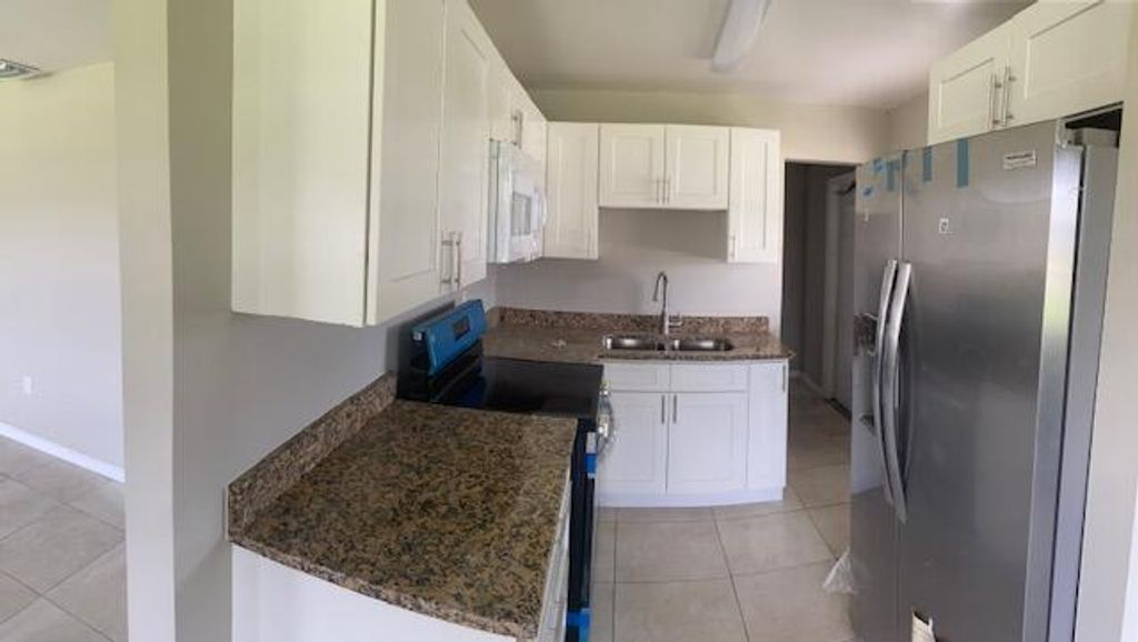 Photo of 604 SW 13th Street, Belle Glade, FL 33430 (MLS # R10990423)