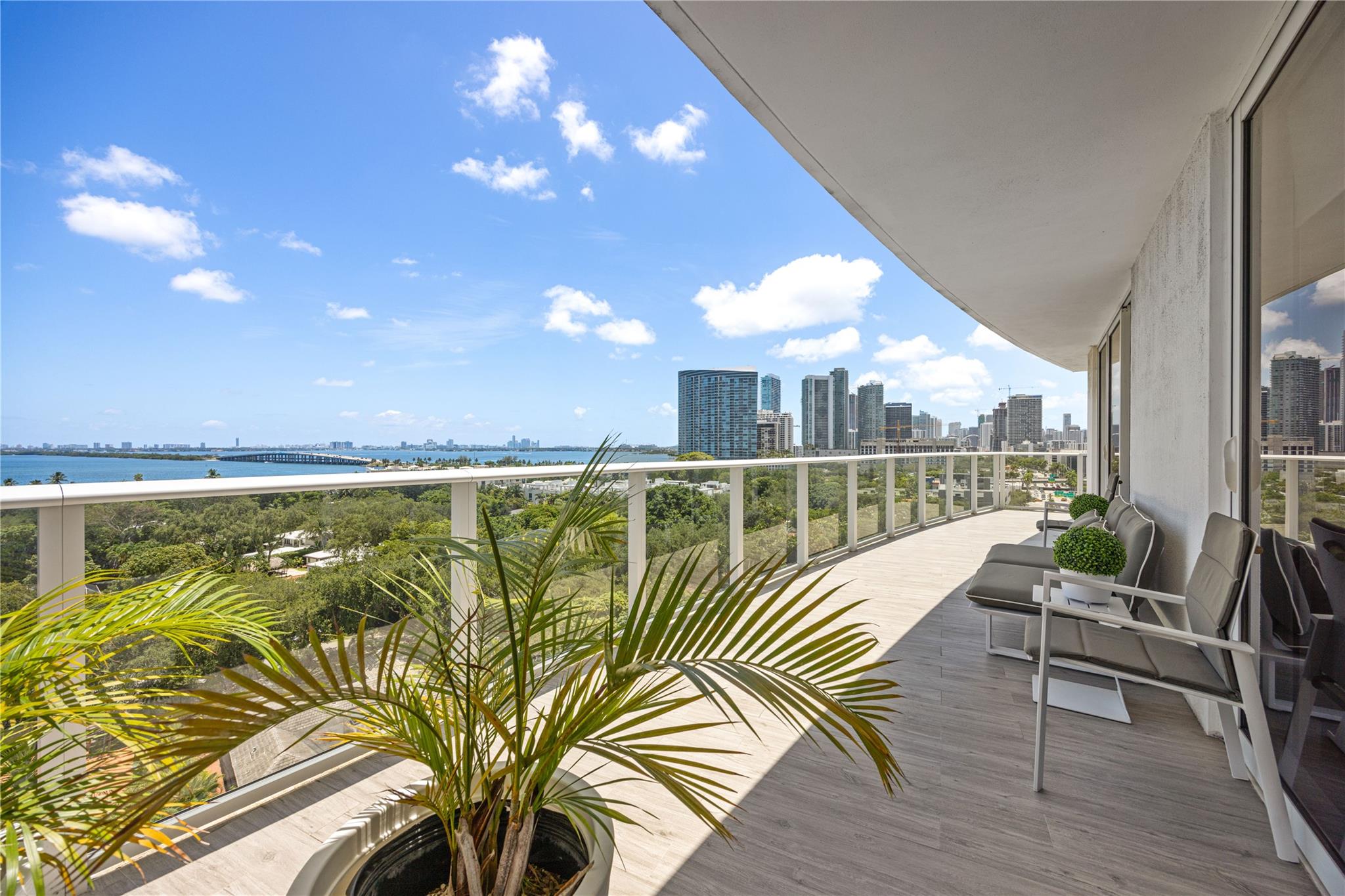 This stunning 2-bed, 2-bath residence sits on the 11th floor of a luxury high-rise and offers unobstructed views of Biscayne Bay and Miami Beach. Enjoy spectacular sunrises and moonlit evenings from the expansive wraparound balcony-terrace. Floor-to-ceiling, high-impact glass doors and windows flood the space with natural light and offer unmatched vistas from every room. Includes 2 covered parking spaces and is located in a strictly residential building featuring top-tier amenities: state-of-the-art gym, resort-style pool, rooftop jacuzzi, entertainment lounge, 24-hour security, and excellent maintenance and cleaning services. A rare opportunity to live in a peaceful, well-maintained community close to Design District, Midtown, and Miami Beach. Only 10 mins from Miami Int’l Airport.