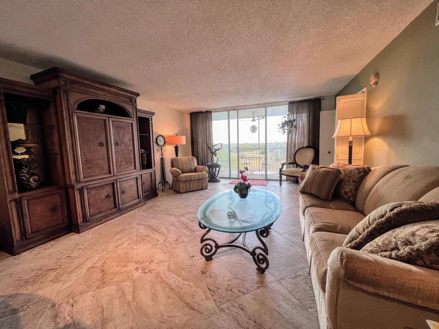 Perfectly positioned 6th floor corner unit in sought after Palm Aire golf community. Lovely screened-in balcony overlooking a serene lake with beautiful sunset views creates the perfect place to unwind. Welcoming foyer entrance opens to a light and bright interior featuring neutral tile flooring throughout the main living areas. This spacious 3-bedroom, 2-bath residence offers an ideal layout with great natural cross breezes enhancing comfort year-round. Original kitchen and bathrooms provide a fantastic opportunity for customization, allowing you to design and finish to your exact taste and style. Generous living and dining spaces are perfect for everyday living or entertaining. A wonderful opportunity to create your dream home in a peaceful setting with tranquil water views.