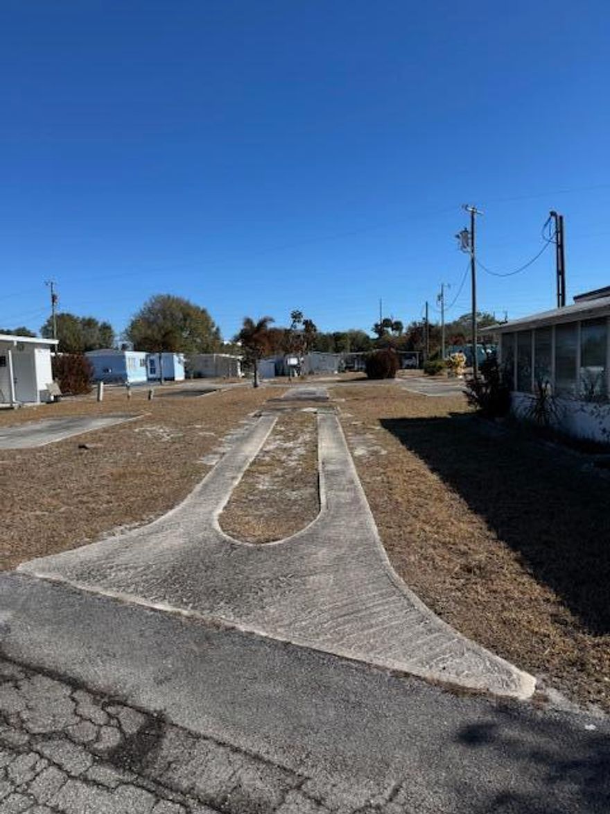 55 + CO-OP Community, Whispering Creek. Vacant Lot...Ready for Your Mobile Home or Tiny Home! That's right...TINY HOME APPROVED! This cleared and ready-to-go lot is nestled in a welcoming CO-OP community where you OWN a share in the park, not a land lease! Unbelievably low HOA...only $255 a month! The lot comes with power and water hookups, so bring your vision and settle into affordable Florida living with ease. Whether you're dreaming of a cozy mobile home or a trendy tiny home escape, this is your blank canvas in a peaceful, community-oriented setting.