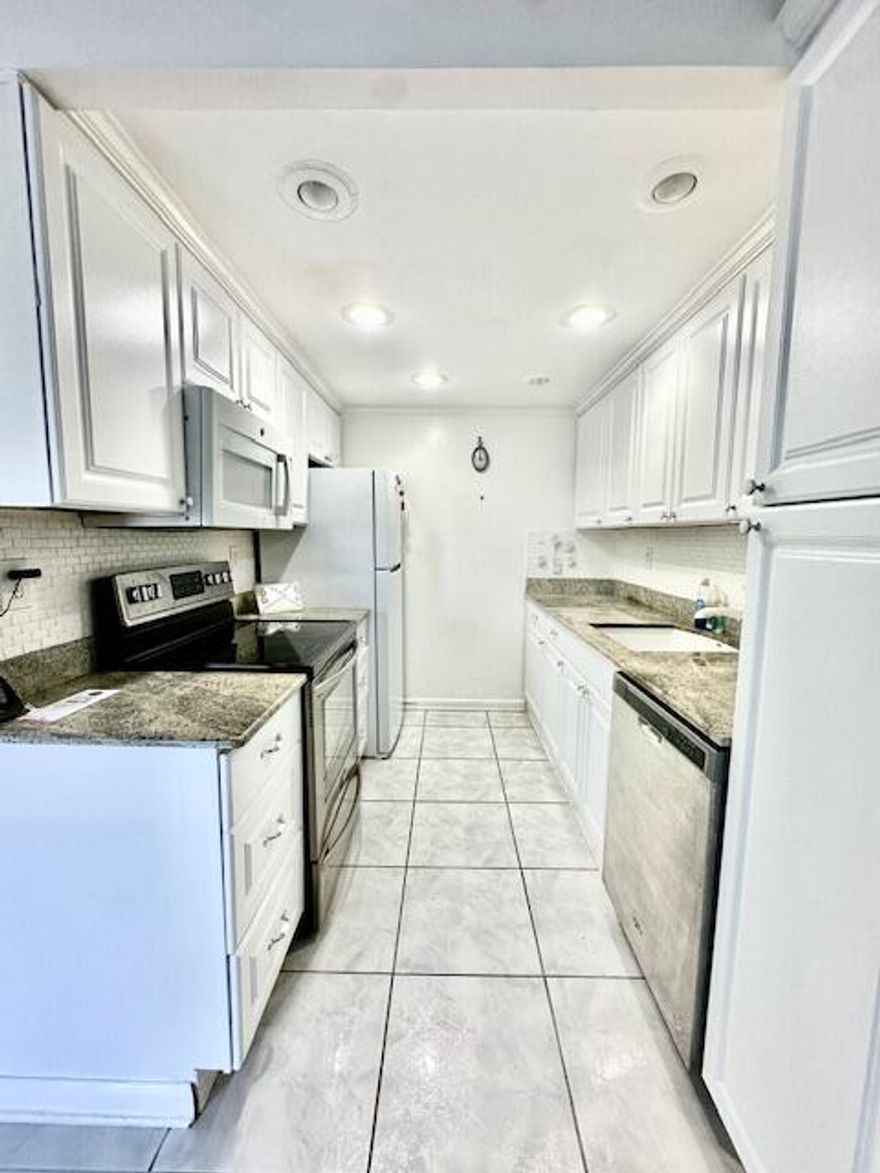 Discover serene, first-floor living in this beautifully updated 2-bedroom, 1.5-bathroom home.  The kitchen has been modernly renovated and includes a convenient pantry and recessed lights. Tile flooring throughout. While the contemporary bathrooms offer a sleek, walk-in shower - no tub. The true highlight is the enclosed patio, your private retreat to sit back, relax, and soak in the breathtaking, magnificent lake views. Apt comes with one assigned parking spot, and storage cage in Laundry room. Century Village is like living in a resort, fitness center, live shows,movies,buses,classes,bingo,card rooms,trips,tennis,pickelball,close to shopping and restaurants,come see and then check out the clubhouse to see it for yourself. Per the association this is a 55 plus community!!! This is a must see !!!