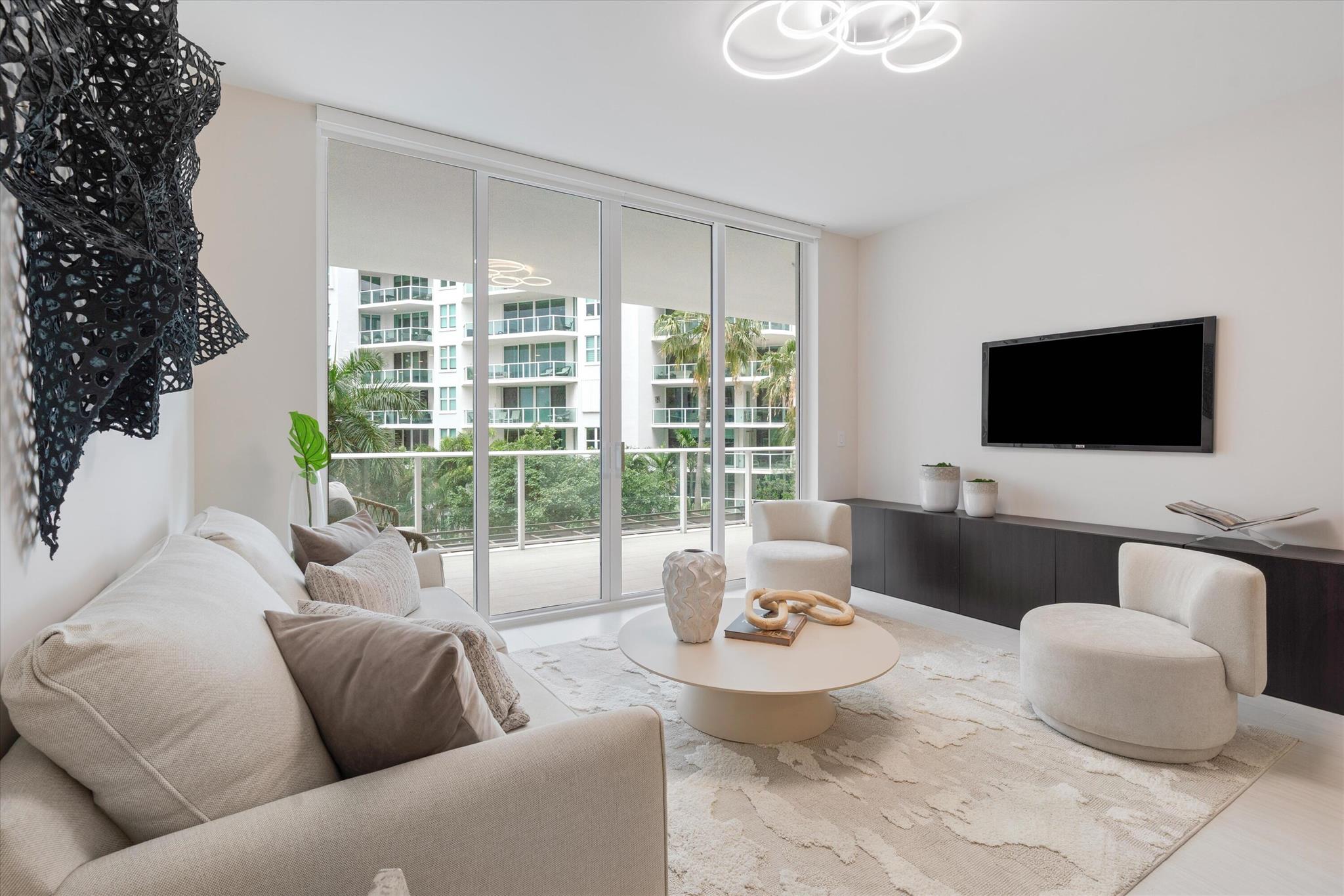 Experience refined living in the heart of downtown Boca Raton at ALINA Residences. This newly completed 4th floor condo, with desirable southeastern exposure, is move-in ready and seamlessly combines modern elegance with everyday comfort. The thoughtfully designed layout includes a spacious primary bedroom, a versatile den, and two full bathrooms--offering both style and functionality. The light-filled, open-concept living space is framed by expansive floor-to-ceiling sliding glass doors that open to a generous south-facing terrace, perfect for relaxing with picturesque golf course views or enjoying al fresco dining. Every detail has been meticulously selected, from motorized custom shades and built-in closets to sophisticated Italian finishes. The chef's kitchen features premium Gaggenau