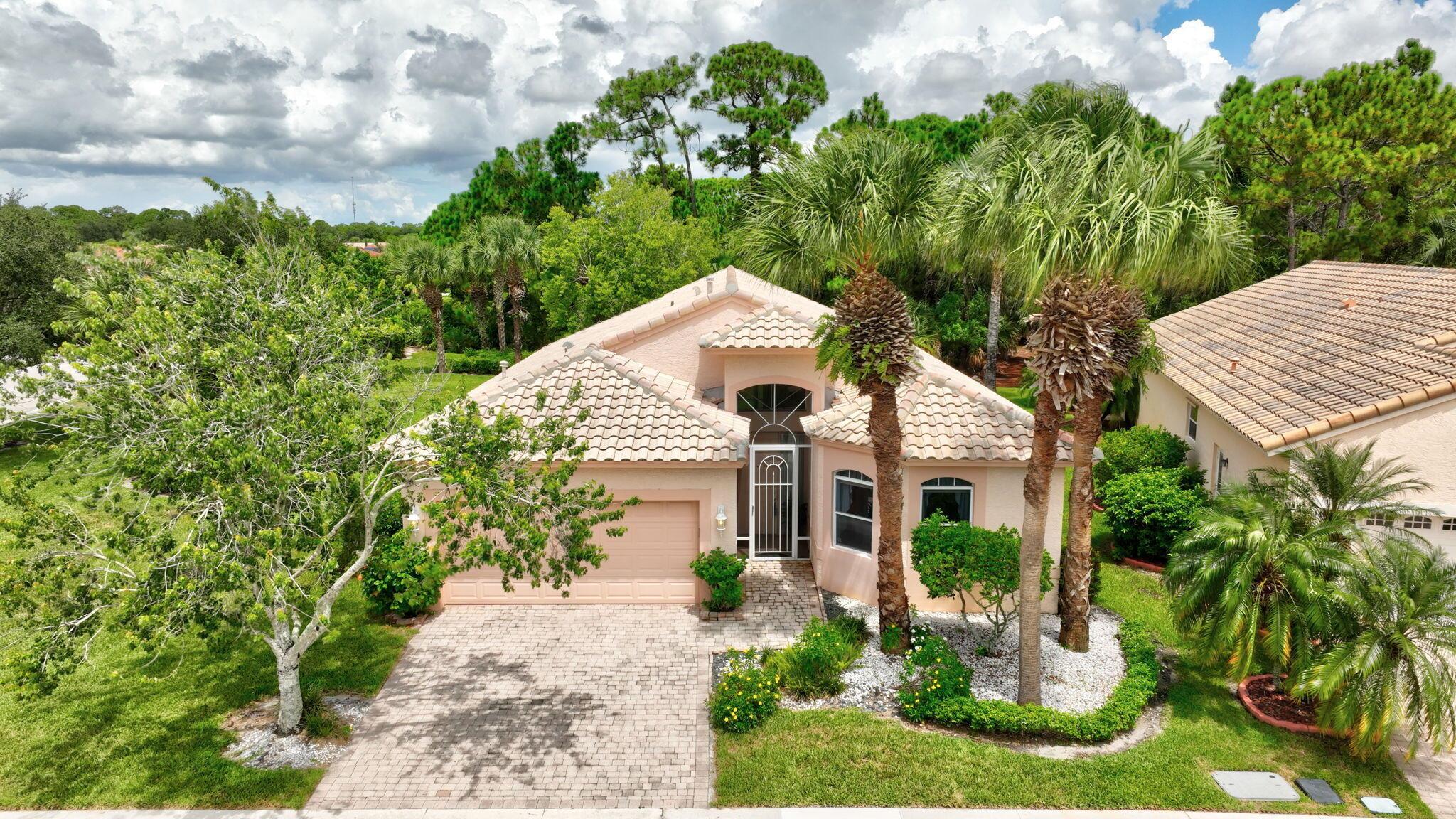 Rare private preserve and corner lot with no backyard neighbors, nestled in the sought-after 55+ lifestyle community of The Cascades at St. Lucie West. This stunning 3 bedroom, 2 bath home is perfect for embracing the Florida lifestyle. Neutral tile throughout, vaulted ceilings and split bedroom plan. Gourmet kitchen features upgraded cabinetry, granite counters and a natural gas cooktop. Spacious living / dining areas perfect for entertaining. The owner's suite offers space for a sitting area /office and 2 walk-in closets. Luxurious owner's bath boasts his and her vanities, inviting oversized Roman tub, separate glass shower and water closet. Relax on your screened lanai overlooking the serene private preserve, and enjoy the tranquility of your surroundings. New AC 2022.