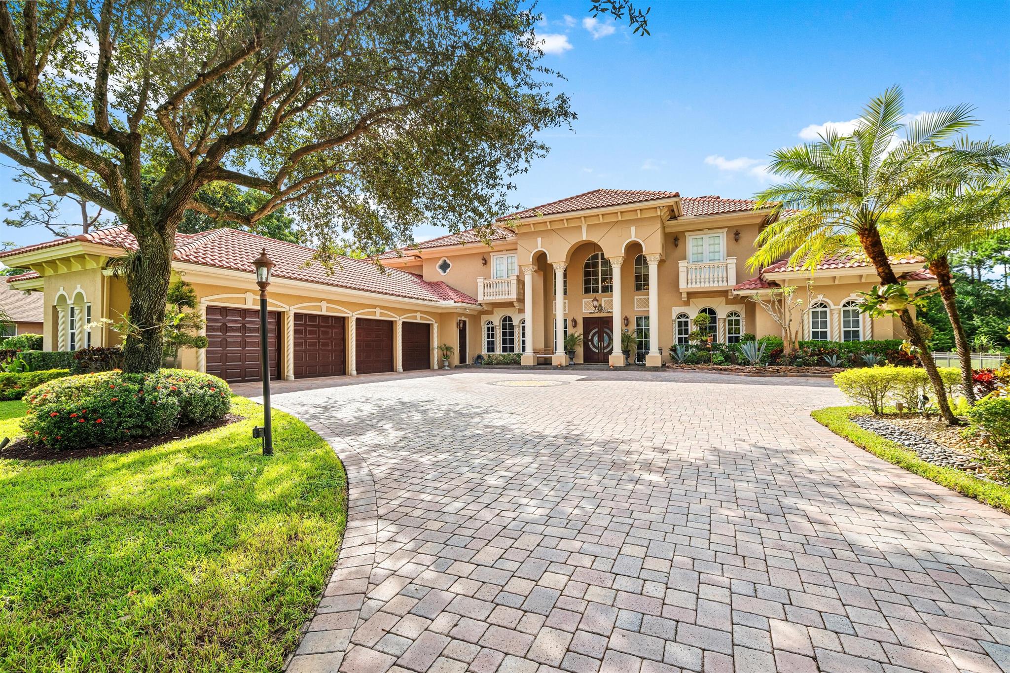On more than an acre of meticulously maintained landscaping, the paver driveway leads to the impressive front entrance creating a welcoming first impression. Inviting outdoor living, the loggia and summer kitchen overlook the expansive patio centered on a sparkling resurfaced saltwater pool with an overflow spa.Discover this exceptional five-bedroom, 7,621+/- square-foot masterpiece in Pine Tree Estates, Parkland, perfect for luxury living, privacy and hosting. A tribute to elegance, the dramatic two-story foyer, with a gracefully curving staircase, introduces the grand two-story living room, with a fireplace and bank of sliding glass doors adorned with arched windows, revealing pool and garden views. Enjoy special gatherings in the formal dining room or opt for casual comfort in the