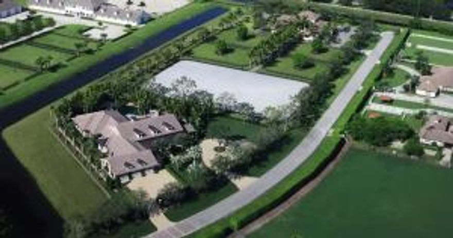 With a quiet elegance and exquisite design, this stunning custom built estate offers an unmatched location within the exclusive Mallet Hill community. Encompassing 5.6 acres, the serene estate boasts 4 bedroom suites, 2 half baths, steam shower, custom office, fitness center, wet bar, gourmet kitchen with 4 ovens, heated resort-style salt water pool with a water feature, koi ponds, fire pit, air conditioned 3.5 car garage, patio bar and botanical gardens that offers the ultimate South Florida equestrian lifestyle. The custom built 10 stall barn, with expansion potential, has an owner's lounge/ tack room with a kitchen, screened porch, laundry room and 2 half baths. The upper story occupies a 2 bedroom, 1 bath trainer's quarters with a full kitchen, living room and views of the WEF show