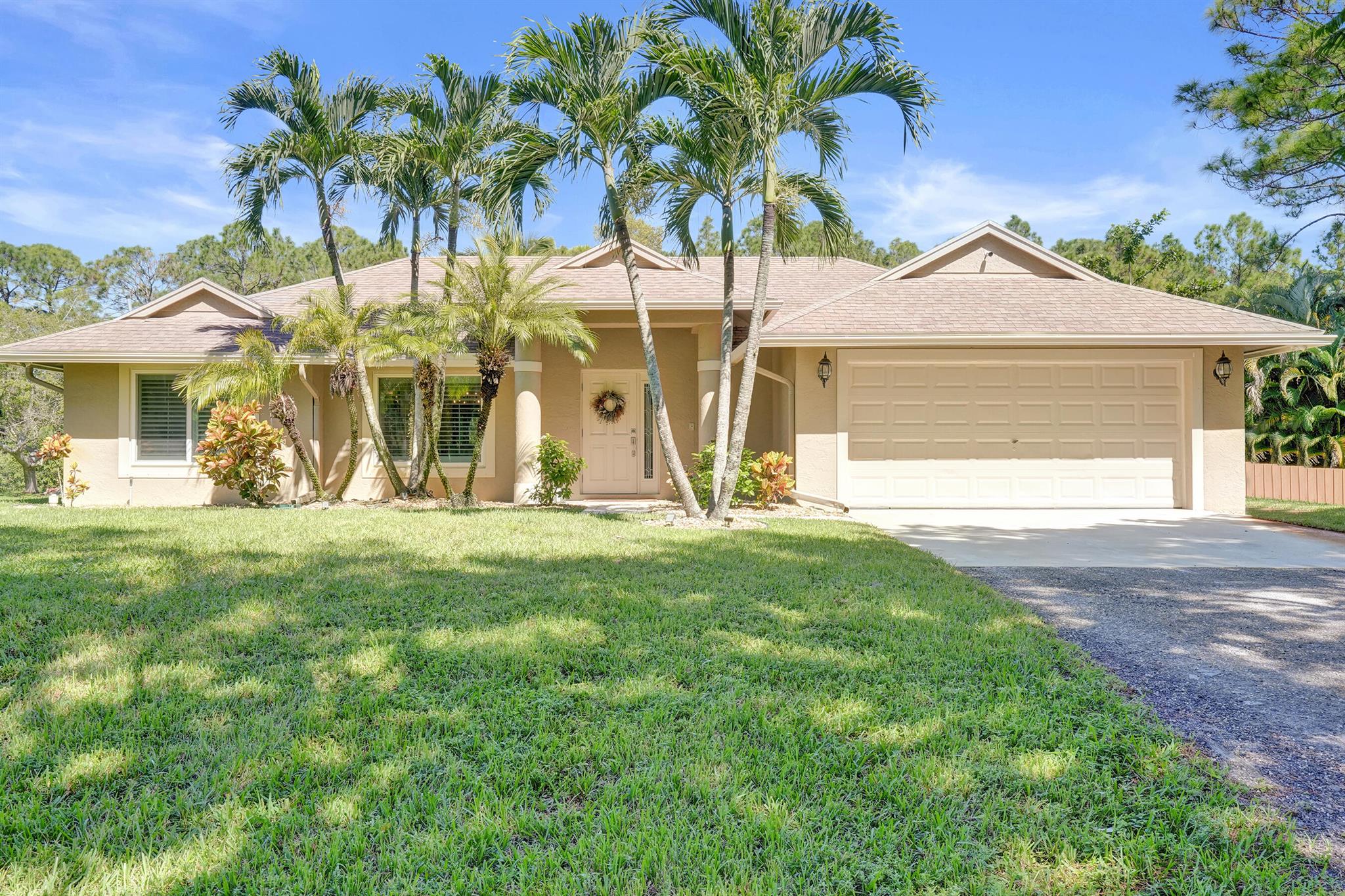 Welcome to your private paradise in the heart of Loxahatchee! This beautifully remodeled home sits on nearly 1.3 acres, offering the perfect blend of luxury, comfort, and outdoor living. The resort-style backyard is ideal for entertaining--featuring a sparkling pool, spacious tiki hut, screened patio, built-in fire pit, and horseshoe area for family fun. Inside, a stunning newly renovated kitchen with modern finishes opens to bright living spaces with high vaulted ceilings. Freshly updated bedrooms and baths include new flooring and stylish details throughout. The property is secured by an electric front gate, plus a second double-gated entry perfect for RVs, boats, or trailers. Experience the best of the Loxahatchee lifestyle in this truly exceptional retreat.