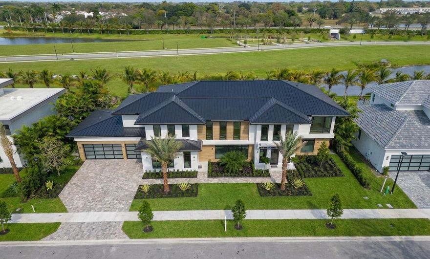 Welcome to Farrell Estates, a premier 27-home enclave in the Palm Beach Polo Club. Lot 22 commands attention with over 7,700 living sq. ft. and 10,000 total sq. ft. of architectural excellence. A grand staircase and two-story foyer lead to a main level finished in grand porcelain tile, featuring an open-concept family room, side bar, and chef's kitchen. This level includes a Junior suite and a unique flex-wing with a separate entrance, perfect for a gym or office. Upstairs, warm oak floors flow through five ensuite bedrooms and an expansive bonus room. The primary sanctuary offers a private sitting room and spa-like bath. Outside, a 1,000+ sq. ft. patio with a pool and spa defines Hamptons-style luxury. Experience a residence designed for the most discerning buyer. The immense scale of Lot 22 is matched by its meticulous detail. The 10,000+ total square footage includes a massive 1,000+ sq. ft. second-story terrace, offering a breathtaking venue for evening cocktails. Inside, a personal elevator provides seamless access, while 2.25-inch solid core doors ensure ultimate privacy. Effortless estate management is guaranteed with dual laundry centers upstairs and downstairs each equipped with two washers and two dryers. Every finish is bespoke, from custom cabinetry to stunning quartzite countertops. The primary wing is a masterclass in luxury, featuring dual walk-in closets and a freestanding tub. Complete with a three-car garage for your collection, Lot 22 at Farrell Estates represents a curated lifestyle of sophistication and grandeur.