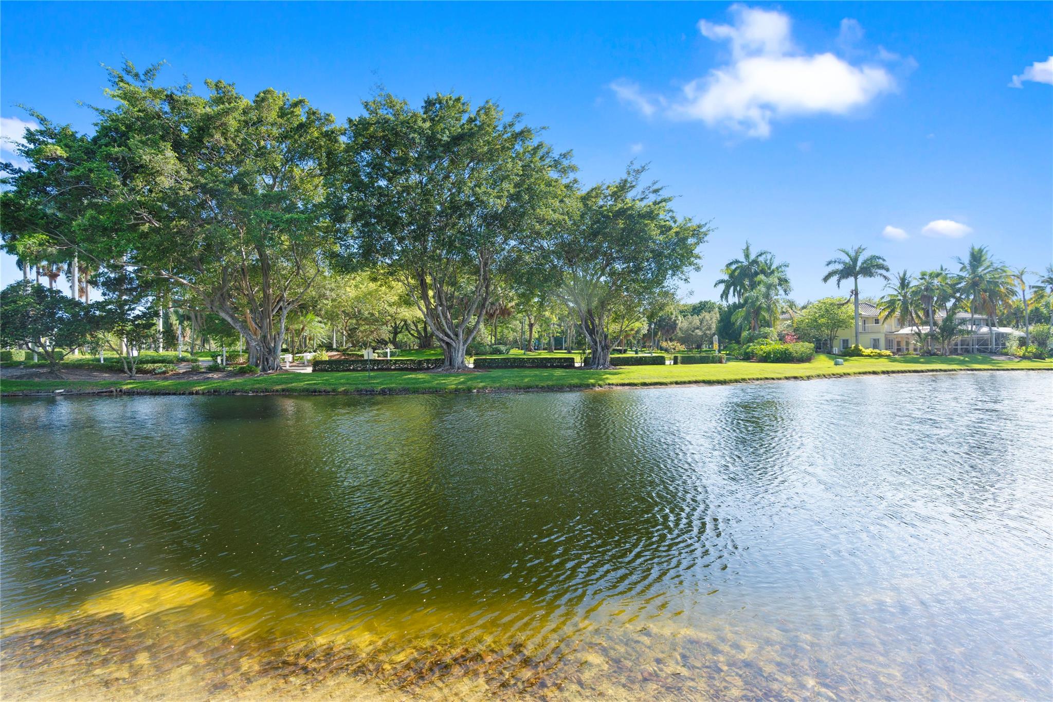 SPECTACULAR LAKE VIEWS FROM THIS UPDATED 3 BEDROOM 2 BATH HOME WITH 2 CAR GARAGE IN DESIRABLE COMMUNITY OF HERON LAKE II IN COUNTRY ISLES OF WESTON*BEAUTIFUL WOOD LIKE TILE FLOORS THROUGHTOUT *SPACIOUS PRIMARY BEDROOM WITH WALK-IN CLOSET AND REMODELED BATH*EAT IN KITCHEN WITH 42"CABINETS, STAINLESS STEEL APPLIANCES, GRANITE COUNTER TOPS AND TILE BACKSPLASH*SPLIT FLOOR PLAN*VAULTED CEILINGS*UPDATED LIGHT FIXTURES, CEIILING FANS, & BASEBOARDS*ROOF (2013)*AC (2015)* ENJOY PEACEFUL VIEWS OF THE LAKE & COUNTRY ISLE PARK FROM THIS HUGE COVERED AND SCREENED IN PATIO-GREAT FOR ENTERTAINING*SHOWS GREAT!
