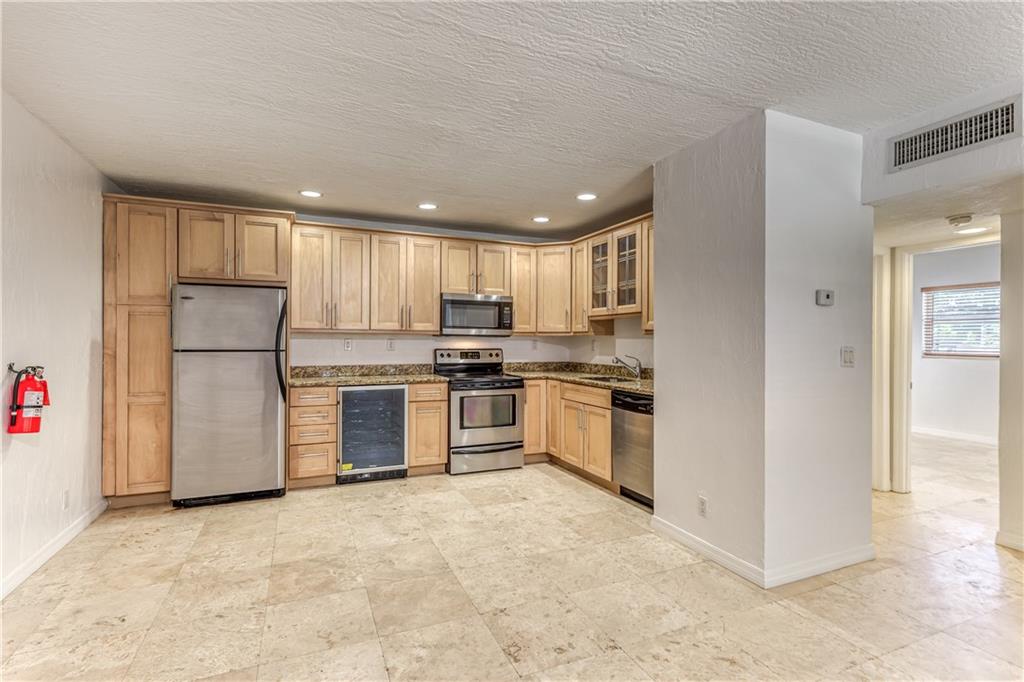 This completely renovated large corner unit has all the upgrades; travertine floors throughout, stainless steel appliances, wine cooler, granite counter tops, maple cabinets, recessed lighting, impact windows and central AC. Located near downtown Fort Lauderdale, Wilton Drive, shopping and nightlife, but in a quiet residential neighborhood. Outdoor grill area with table for cooking out. Laundry on premises. Rapid Approval. Unfurnished. Easy to show. No smokers or pets please. Call today!