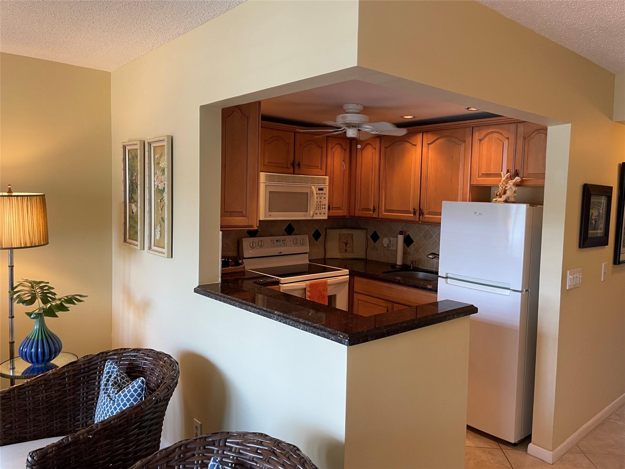ENCHANTING WINTER GET-AWAY.. 1ST FLOOR, STEPS TO VENTNOR POOL, ACROSS FROM TENNIS COURTS. PARKING SPACE IN FRONT OF YOUR DOOR! UNIT FEATURES PLANTATION SHUTTERS, 2022 A/C, 2022 W/H , 2018 ELECTRIC PANEL, ALL TILED DIAGNOL, OPEN KITCHEN W/ MAPLE CABINETS, TUMBLED STONE BACKSPASH, UNDERMOUNT LIGHTING & RICH GRANITE COUNTER TOPS. UPDATED BATHROOM W/ WALK IN SHOWER! ENCLOSED ZEN PATIO SURROUNDED BY GREENERY. 5 STAR CLUBHOUSE WITH CLUBS AND CLASSES GALORE! STATE OF THE ART GYM, FABULOUS BALLROOM FOR DANCING & CELEBRATIONS. GRAND THEATRE FOR MOVIES & LIVE SHOWS. PICKLEBALL,TENNIS, MINATURE GOLF, SHUFFLEBOARD, PING PONG, BILLIARDS AND SO MUCH MORE! RESTAURANT FOR YOUR PLEASURE, FREE TRANSPORATION IN A GATED COMMUNITY W/ 24 HR SECURITY. CLOSE TO GREAT EATERIES, SHOPPING & 3.5 MILES FROM THE BEACH!
