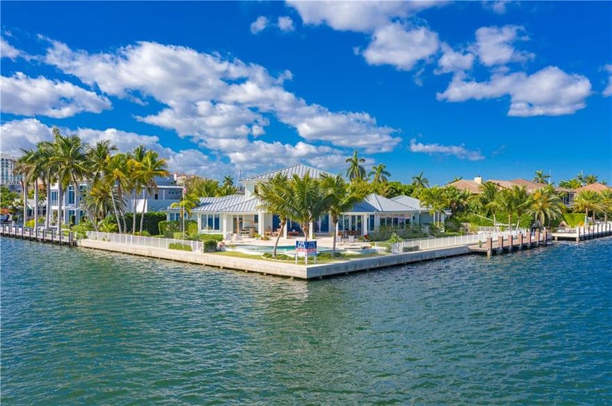 Stunning British West Indies estate on over half an acre point lot w/arguably some of the best City and Intracoastal views in FTL! Designed by award winning Tuthill Architecture & winner of multiple Community Appearance Awards. This stunning home features high end finishes, warm wood floors, wine room, gym, an open floor plan, eat in gourmet kitchen & master bedroom on ground level w/dual baths & walk-in closets. Light & bright w/ample windows to enjoy the water views & constant boat parade. Generator. Gated property w/vast covered verandas, salt water pool & oversized backyard. Mega yacht dockage w/ over 300' on water & 45' boat slip. A boater's dream, just moments to the ocean! Conveniently located close to downtown, shopping, fine dining, nightlife, air & sea ports & major highways.