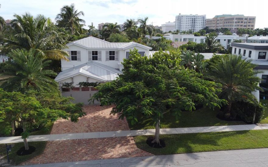 Don't miss this opportunity to live steps away from Mizner Park in East Boca Raton's most prestigious neighborhood. As you enter the home you will be blown away by 12-14 foot soaring ceilings and an open floor plan bathed with natural light. The updated eat-in kitchen features gas cooking, 2 ovens and 2 sinks overlooking the modern saltwater pool. The Master Suite downstairs includes a sitting area (or home gym), 2 separate walk-in closets, spacious Master Bath with 2 Marble Vanities and a clawfoot tub. Executive office downstairs with double doors for privacy. Upstairs are 3 large bedrooms plus a flex space that could be a playroom, homework area, home theater or office. The home is complete with Hurricane Protection and impact doors. Fully transferrable termite bond.