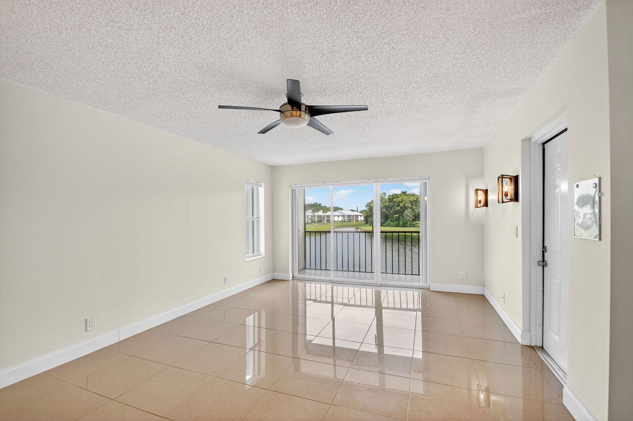 Welcome to this beautifully updated 2 bed, 2 bath condo in the gated community of Palm Club Village, where serene lake views greet you from every window. This private 2nd-floor home offers a secluded entrance away from the parking area, an updated kitchen and bathrooms, bright, open living spaces, and accordion shutters for added peace of mind. Enjoy the convenience of an in-unit laundry room and access to community amenities including a pool, tennis courts, racquetball, walking trails, and 24-hour security. Ideally located near Downtown West Palm Beach, Palm Beach International Airport, I-95, and the Brightline, this condo combines comfort, privacy, and lifestyle in one perfect location.