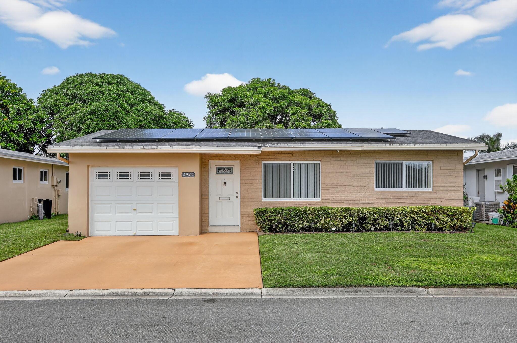 Charming Home in a 55+ Community - Fully Remodeled!  Two bedrooms, two bathrooms, and one car garage. It is equipped with solar panels installed on the roof, which can significantly reduce your electric bill. The home also has a ready-to-use electric car charging setup.Enjoy clean, mineralized drinking water with a high-quality filtration system that includes three separate water outlets--for the kitchen sink, coffee maker, and refrigerator.Located in the desirable Paradise Gardens Section III community, residents enjoy access to a beautiful clubhouse with a swimming pool, gym, and various other amenities. The community is ideally situated near Atlantic Blvd., State Road 7/U.S. 441, Lakewood Shopping Center, Margate Plaza, HCA Florida Northwest Hospital, and much more.