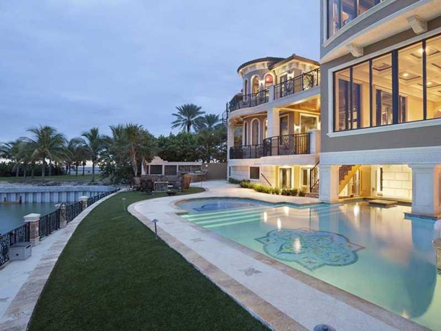 Fronting the Hillsboro Inlet with 100± feet of deepwater shoreline plus another 127± feet of sandy beachfront, this 3-story majestic Mediterranean Revival estate looks across to the historic Hillsboro Lighthouse and out to the Atlantic waters. The stunnin g resort-style outdoor entertainment area provides a loggia by the mosaic-inlaid pool featuring a spillover spa, fire-pits, sun shelf, swim-up bar and summer kitchen. The property is complete with multi-boat dockage right by the entrance to the ocean.