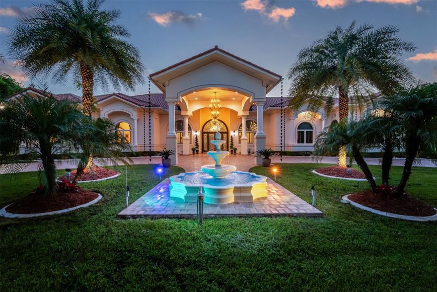 **EXPERIENCE TIMELESS LUXURY IN THIS EUROPEAN SPANISH-STYLE VILLA.*** NESTLED IN THE PRESTIGIOUS HEART OF SUNSHINE RANCHES, THIS BREATHTAKING 5-BEDROOM 7-BATH ESTATE BLENDS CLASSIC ELEGANCE WITH MODERN SOPHISTICATION. FROM THE MOMENT YOU STEP INSIDE, SOARING HIGH-VOLUME CEILINGS, EXPANSIVE PORCELAIN FLOORS AND WALLS OF FLOOR-TO-CEILING GLASS FLOOD THE HOME WITH NATURAL LIGHT & PANORAMIC VIEWS. THE GOURMET CHEFS KITCHEN FLOWS SEEMLESSLY INTO INVITING LIVING AND LOUNGING AREAS-PERFECT FOR HOSTING GATHERINGS WITH FAMILY & FRIENDS. STEP OUTSIDE TO A COVERED PATIO COMPLETE WITH A FULLY EQUIPPED SUMMER KITCHEN, OVERLOOKING LUSH TROPICAL GARDENS AND A RESORT-STYLE POOL OASIS THAT INVITES YEAR-ROUND RELAXATION. THIS EXCEPTIONAL RESIDENCE IS MORE THAN A HOME-IT'S A LIFESTYLE.