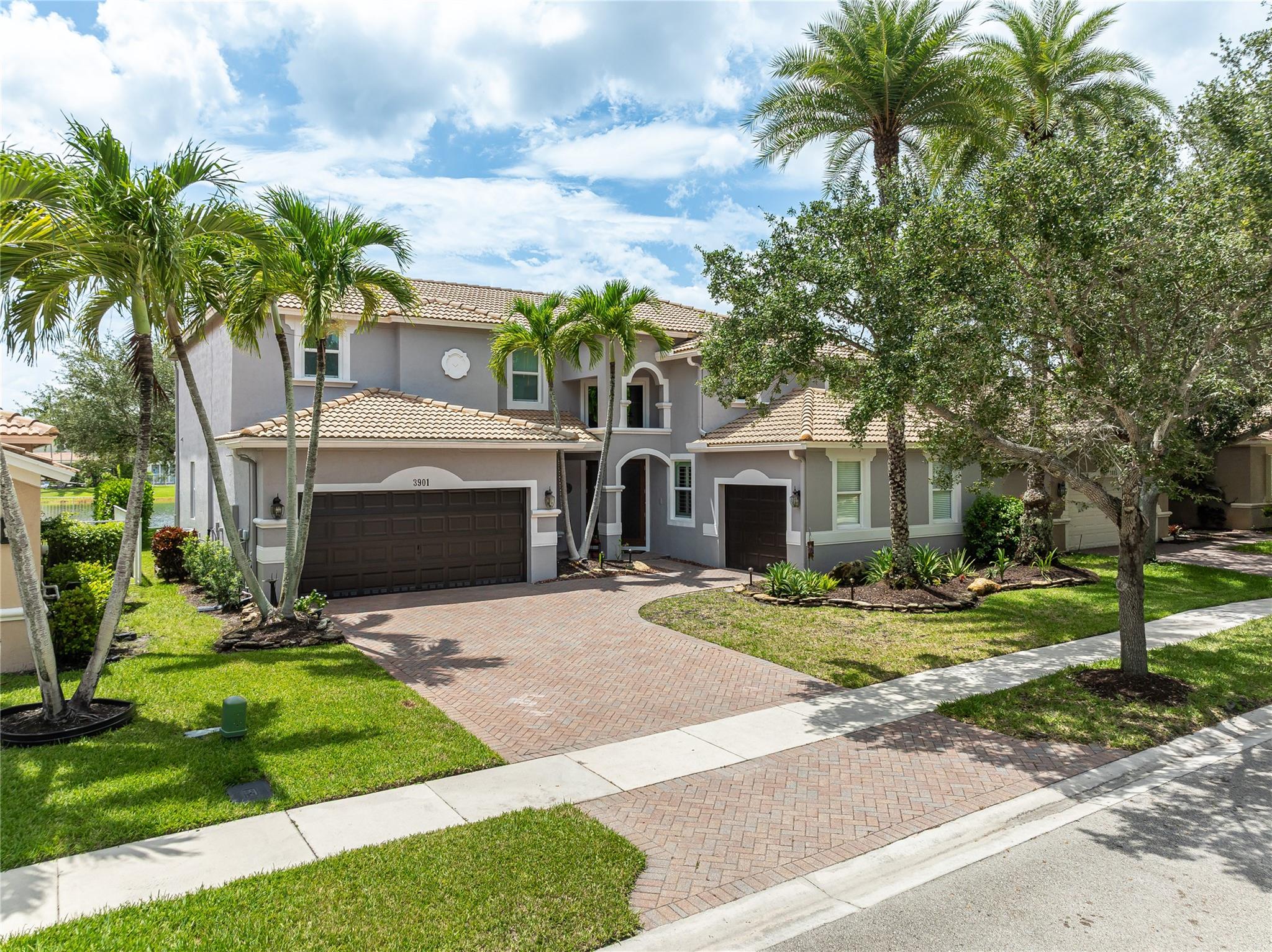 Remodeled 5BR/3BA lakefront residence in Isles of Weston offers 3,410 SF of elevated living with panoramic, tranquil water views. Rare model with open sightline from entry to lake. Hurricane-ready with full impact windows/doors featuring multi-point locking and generator ready. Interior upgrades include solid core doors, gourmet kitchen with walk-in pantry, stainless steel appliances, Bosch ultra-quiet dishwasher, and smart tech: WiFi-enabled water heater & 3-zone sprinkler system. Freshly coated garage doors, whole-house water filtration. Located in a meticulously maintained guard-gated community near top-rated Weston schools and upcoming Vista Park sports complex with new astro turf fields. Perfect way to start the school year. Well priced and a pleasure to show. Show and sell!