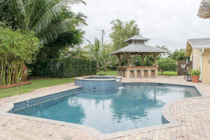 This beautiful tropical home features 6 bedrooms and has 5 full baths,almost 1 acre, at the end of a cul-de-sac, and only minutes from Downtown Delray Bch.Beautiful landscaping with outdoor lighting, pool,Beautiful unique quiet neighborhood,No HOA