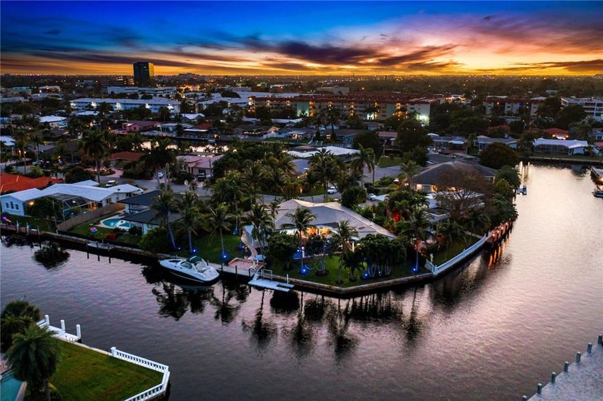 Spectacular point lot. with 157 ft on the water with beautiful views. Split bedroom plan. 4 bedrooms and 3 baths. New updated master bathroom with steam shower and jacuzzi tub. Gourmet kitchen, new a/c, impact windows and doors and security system and cameras. Fenced yard, new she shed, new outdoor kitchen with all amenities., new dock. Beautiful landscaping with new lighting. Only mins to the intracoastal. (NEW METAL ROOF)