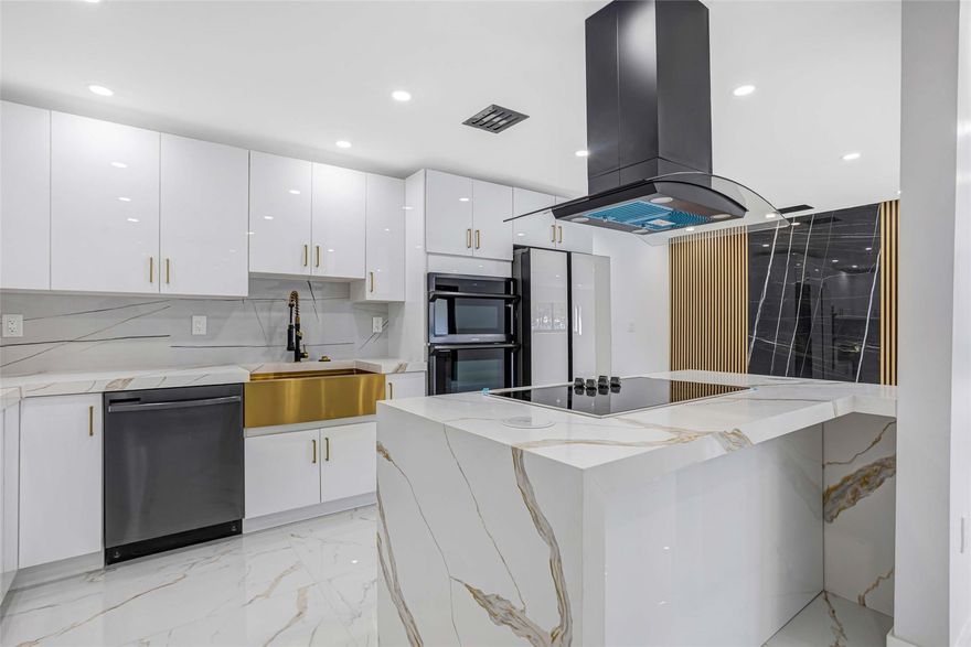 OMG! OMG! Check out this gorgeous completely remodeled SFH done with permits in 2025! This beautiful home has 4 BRs & 3 BTHS with two on suites. Features new roof, all new impact windows & doors, new AC units, new plumbing, all new electrical, including electrical panel and outside electrical service. New HTR, new recessed lights entire house. Checkout the large kitchen with sitting island, Qtz countertops, new S/S appliances, farmhouse sink, cooktop stove, wall oven/microwave combo. Enjoy an open-concept layout, and high-end details throughout. Huge fully fence yard backyard with fruit trees, and plenty of room for pool. Equipped with ring cameras, ring doorbell & eufy smart lock, and nest thermostat. Large porcelain tile throughout, new SOD & new sprinkler system, and so much more.