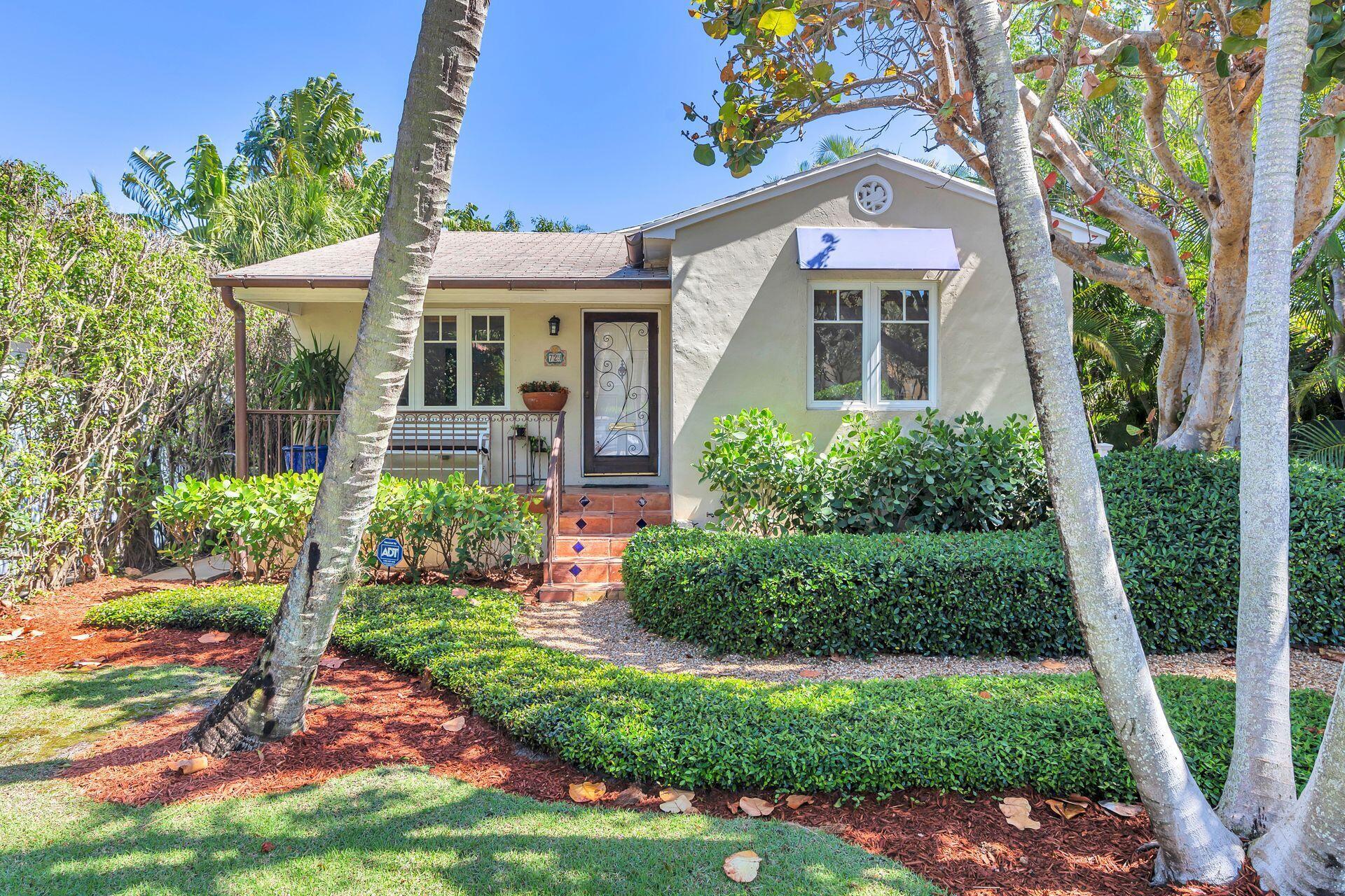 Spectacular Flamingo Park! Finely appointed 2BR/2BTH home, welcoming front porch, large impact windows filling the living space with light, hardwood floors, built in shelves & decorative period touches. Formal living room plus a kitchen/great room addition with soaring wood beams in the vaulted ceiling enhanced with metal brackets embracing the solid architecture. The kitchen features gas range, stainless steel appliances & large island. Formal dining room with bar & French doors. The primary suite has ample closet space & boasts an ensuite bath. The 2nd recently renovated bedroom features a large closet & French doors. The backyard features lush landscaping for private outdoor living. Close proximity to Palm Beach Island, PBIA, Grandview Public Market, The Square (CityPlace) & Antique Row