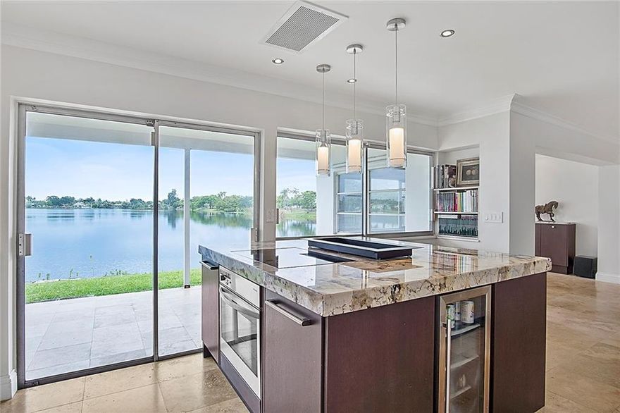 Wow!  2BR 2BA home sits on 76' of lakefront, with one of the most beautiful views, located in rapidly appreciating Royal Palm Acres! No expenses spared!  Home is meticulous inside & includes: marble flooring throughout, top of the line Miele appliances in both kitchen & laundry room; Downsview kitchen & laundry cabinetry; and granite & quartz kitchen countertops. Bathrooms feature large format glass tile, granite countertop & accent wall in guest bath, Kohler fixtures, and Pulse Rain Spa showers. All electrical has been upgraded.  Lots of additional lighting with dimmer switches added; crown molding throughout.  Home also includes partial impact windows, storage cabinetry throughout, & matching marble tile in carport & front entrance.  Sq. Ft LA larger than some 3BRs in neighborhood. 0