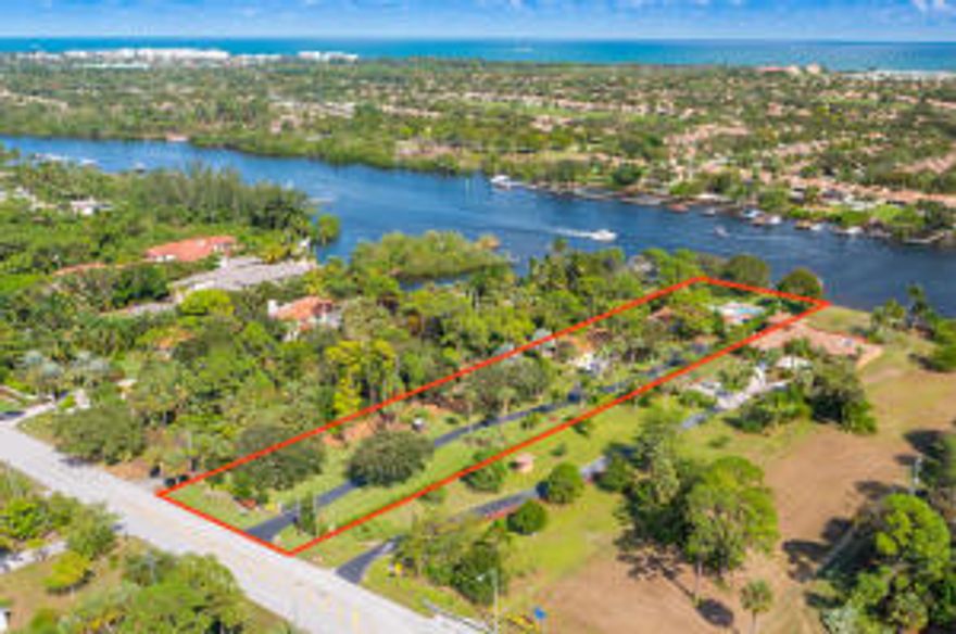 Rare and spectacular direct Intracoastal 1.4 acre property located on secluded Palmwood Road adjacent to The Bears Club and Admirals Cove.  This type property does not  become available very often, and can accommodate up to a 20,000sq Home and guest house, and still have a beautiful yard with panoramic water views.  The existing home is a charming and updated single story 4 Bds / 4Ba / with a detached 4 Car Garage.  The home features all impact doors and windows, open-split floor plan, distressed wood flooring, updated kitchen with wood cabinets & granite countertops.  oversized pool, covered patio overlooking the Intracoastal with fenced yard & private gated entry.  The property features a sound  seawall, with private dock & lift.