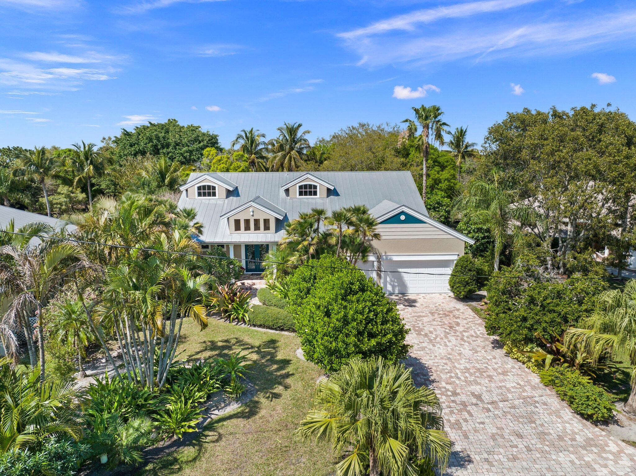 HOUSE APPRAISED AT VALUE AND BUYER LOSS IS YOUR GAIN!! The crown jewel of Sandpiper Bay on .68 acres backing up to Howard's Creek .Experience luxury living in this beautifully crafted Sandpiper Bay estate! Quality solid construction meets elegant design, featuring a gourmet kitchen with a center island, breakfast bar, and built-in desk--perfect for cooking and entertaining. The main floor boasts a formal dining room, spacious living room, second bedroom, home office, and a convenient cabana bath. Upstairs, discover three bedrooms, 2.5 baths, a media room with a wet bar, family room, and loft, offering ample space for guests and flexible living. French doors lead to a stunning 44x22 pool with a spa, expansive patio, and lush landscaping. Impact windows add security and efficiency. Built to