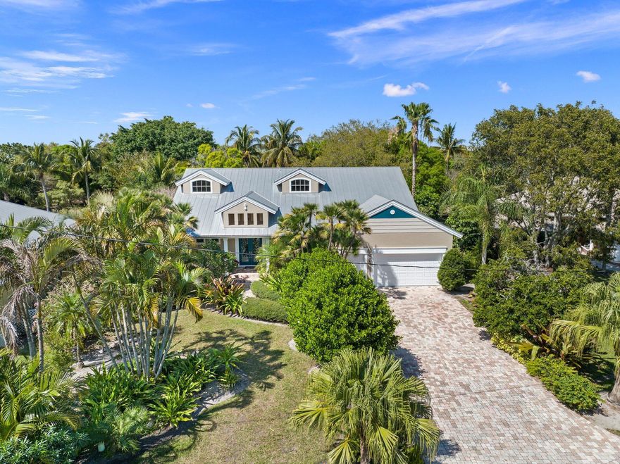 HOUSE APPRAISED AT VALUE AND BUYER LOSS IS YOUR GAIN!! The crown jewel of Sandpiper Bay on .68 acres backing up to Howard's Creek .Experience luxury living in this beautifully crafted Sandpiper Bay estate! Quality solid construction meets elegant design, featuring a gourmet kitchen with a center island, breakfast bar, and built-in desk--perfect for cooking and entertaining. The main floor boasts a formal dining room, spacious living room, second bedroom, home office, and a convenient cabana bath. Upstairs, discover three bedrooms, 2.5 baths, a media room with a wet bar, family room, and loft, offering ample space for guests and flexible living. French doors lead to a stunning 44x22 pool with a spa, expansive patio, and lush landscaping. Impact windows add security and efficiency. Built to