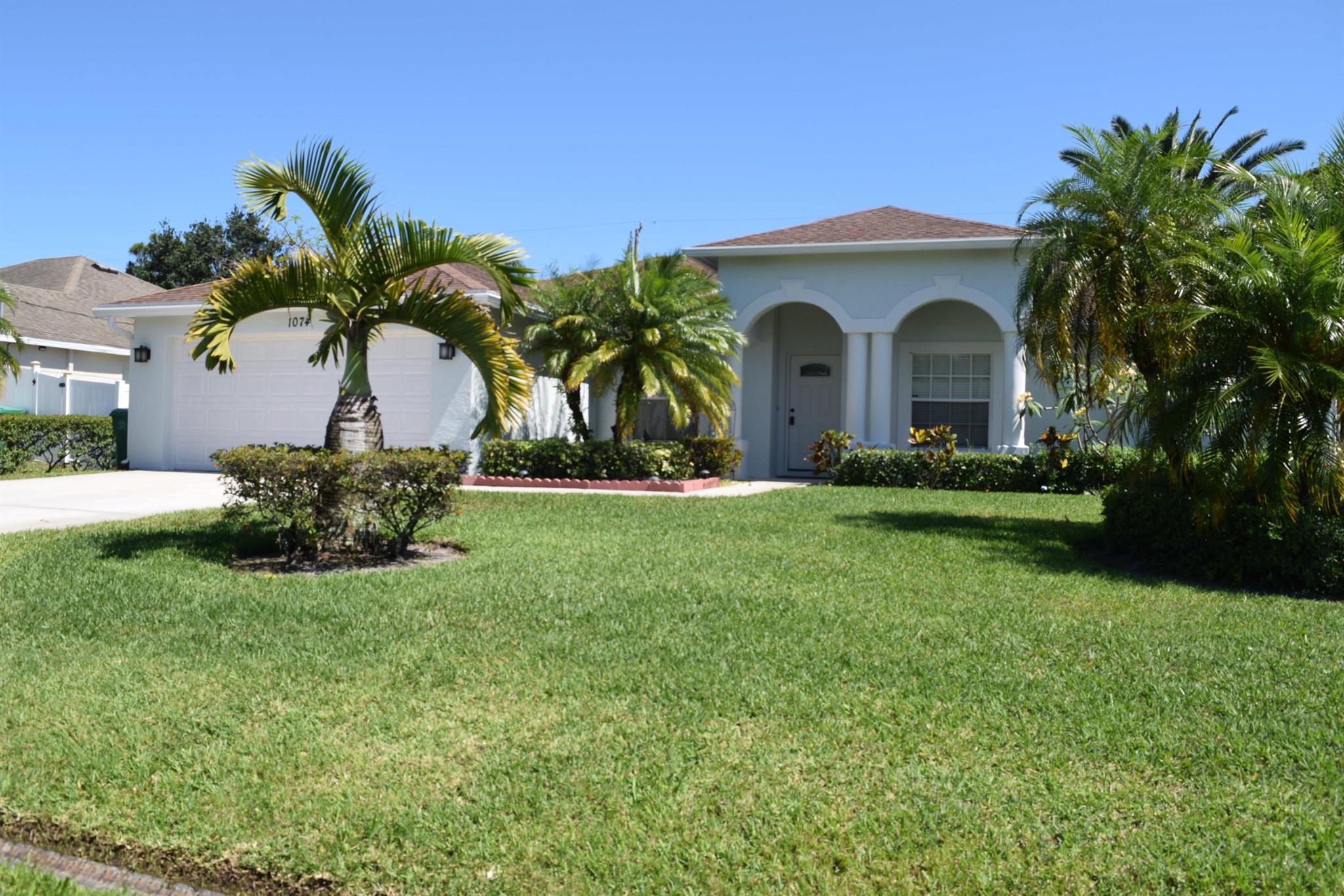 Stunning 4/2/2 home off Paar Drive with lush landscaping, fenced in back yard and large screen porch.  Serene oasis with mature trees great for relaxation and entertaining.  The freshly painted interior has a nice open floor plan with large kitchen, formal dining, living and large family room, a large upgraded gourmet kitchen with granite counter tops and s/s appliances, tiled living areas & Master suite, new luxury vinyl in spacious guest bedrooms, and a newly remodeled master shower.  This home will check all your boxes, centrally located close to major shopping, Tradition and close to I-95 or Turnpike for easy commute. Lawn maintenance included. Take a peek and fall in love, There is no place like home.  Welcome Home!