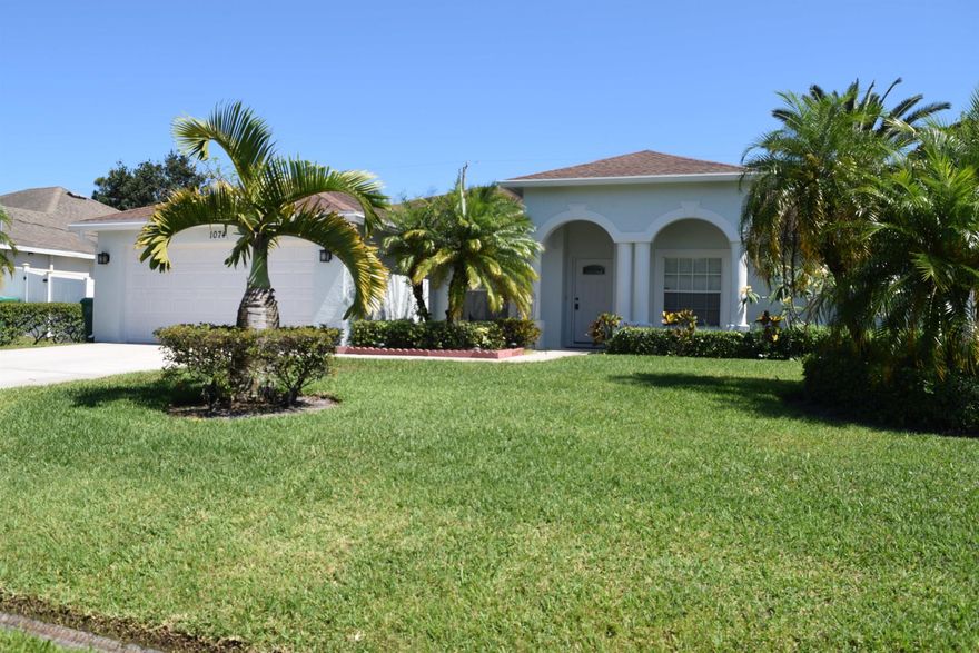 Stunning 4/2/2 home off Paar Drive with lush landscaping, fenced in back yard and large screen porch.  Serene oasis with mature trees great for relaxation and entertaining.  The freshly painted interior has a nice open floor plan with large kitchen, formal dining, living and large family room, a large upgraded gourmet kitchen with granite counter tops and s/s appliances, tiled living areas & Master suite, new luxury vinyl in spacious guest bedrooms, and a newly remodeled master shower.  This home will check all your boxes, centrally located close to major shopping, Tradition and close to I-95 or Turnpike for easy commute. Lawn maintenance included. Take a peek and fall in love, There is no place like home.  Welcome Home!