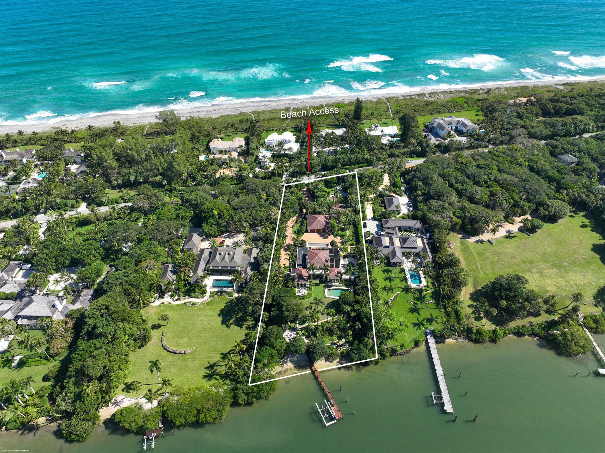 424 S Beach Rd with 172' of direct Jupiter Island Intracoastal frontage sits on almost 2 acres and represents the height of sophisticated, luxury waterfront living. The 6,600+ sq. ft. main house features large entertaining spaces and enormous primary bedroom on the 1st floor with attached officeall with views across to a green preserve. There are two spacious guest rooms upstairs each with ensuite bathrooms and sitting area on the balconies overlooking the water. Outside there are two swimming pools, dock, firepit and verdant gardens surrounding the main house and two guest houses each with one bath, kitchen and living area. Downstairs there is a gym, golf simulator, theater, wine room and workshop. Deeded beach access directly across the street. Quick and easy access to the south bridge