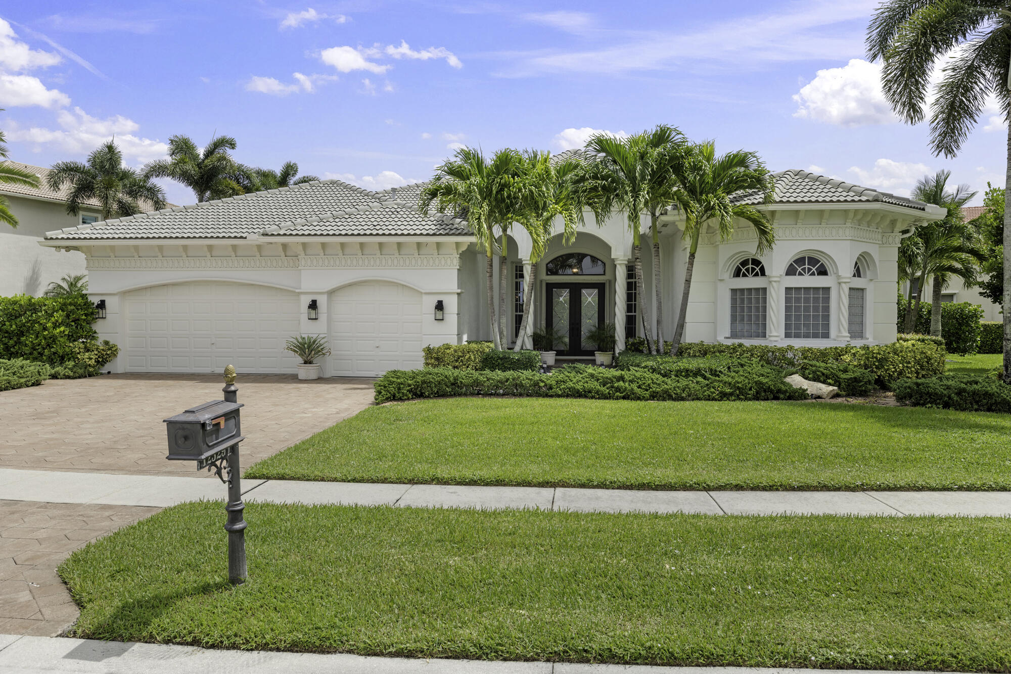 Thoughtfully designed by an upscale interior designer, every detail of this home shines, offering 4 bedrooms and 3.5 bathrooms. It features a triple split floor plan with high ceilings and elegant finishes. The renovated gourmet Kitchen showcases quartz counters, white cabinetry, new appliances, double wall oven, center island with prep sink, reverse osmosis filter & hot water dispenser . Designed for comfort and privacy, two guest bedrooms are en suites, with a fourth bedroom and nearby half bathroom. The primary suite is a luxurious retreat with a spa like upscale hotel feel. All bathrooms have been fully renovated, with a neutral, timeless palette with upscale finishes. Each bedroom features beautiful light oak wood flooring , adding warmth and elegance throughout. Additional features