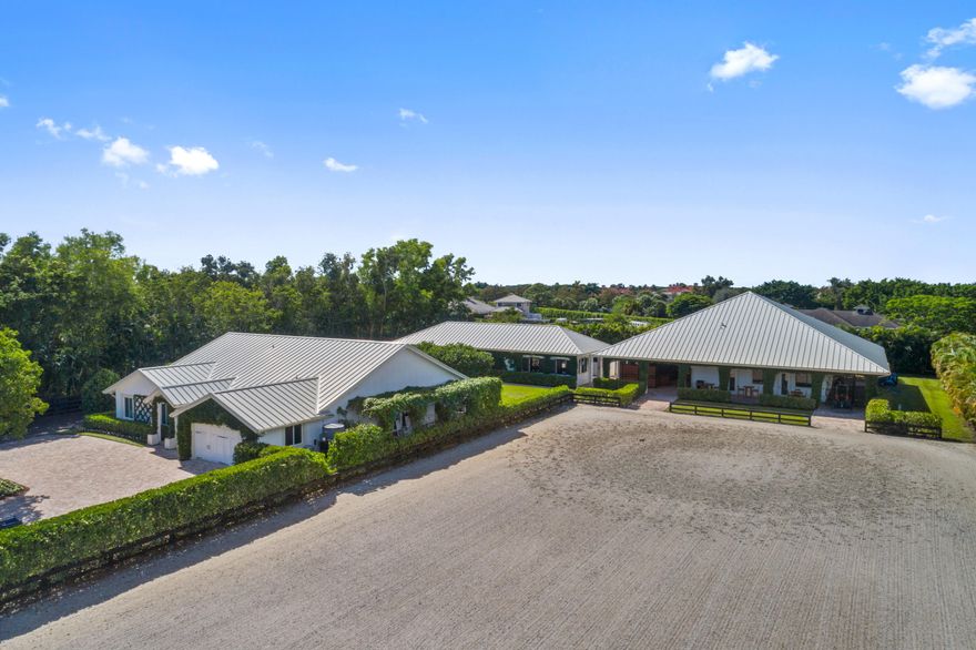 Like a beautiful gem, this swank farm located on the bridle path, just a 5 minute walk from the horse show is a rare find! New barns built in 2016 featuring 13 Röwer and Rüb stalls, two beautiful tack rooms, two feed rooms, laundry and office overlooking the 100' x 200' GGT arena. Custom 2/2 owner's house with chic furnishings, oversized master suite, chef's kitchen, office and dining area. Spacious wrap around outdoor entertainment area overlooking the stable and arena. Adjacent beautifully appointed 2/1 staff house with full kitchen, plenty of parking, four well sized paddocks and luscious landscaping complete this fabulous property. This is a great find for the most discerning and well traveled equestrian. Truly unique!