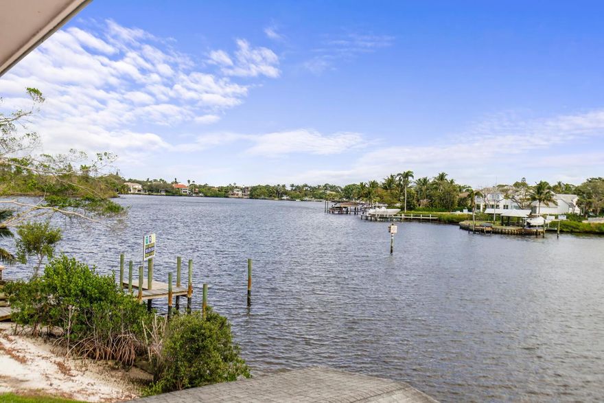 Waterfront Retreat on the Loxahatchee River in Tequesta. Bring your kayak/ paddle board/ fishing pole!  Welcome to this 2 bedroom, 2 bath condo sitting on the corner unit with breathtaking wide-water views from every room. The community features a swimming pool by the water and a day dock. It's unique design gives you lots of privacy, you pull into the first floor open parking garage right by your unit that takes you to your own private courtyard with your own private stairway. Ideal for entertaining and also to relax and unwind as you watch the boats pass by. (this building has an elevator if you prefer) New AC & impact windows. Embrace the charm of Tequesta with local shops, restaurants + just minutes to pristine beaches. Don't miss the opportunity to make this waterfront haven your own