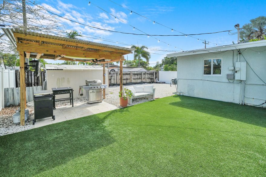 Updated 3BR/2BA home in Wilton Manors on a spacious 7,700 SF corner lot. Features include impact windows & doors, large concrete driveway, and 2-car garage with smart lift system. Interior offers fresh paint, bar area/dining room, large walk-in pantry, and Nest thermostat. Major updates include new AC (2021), flat roof (2024), electrical subpanel (2023), instant electric water heaters, and mostly updated PVC plumbing. Enjoy a private backyard oasis with a new pool (2023) featuring splash pad & umbrella holder, hot tub, 1,000 SF travertine deck, 365 SF artificial turf, and covered grilling area. Includes 11x12 shed and double-wide gates on both sides for boat/RV storage. Low-maintenance landscaping and move-in ready!