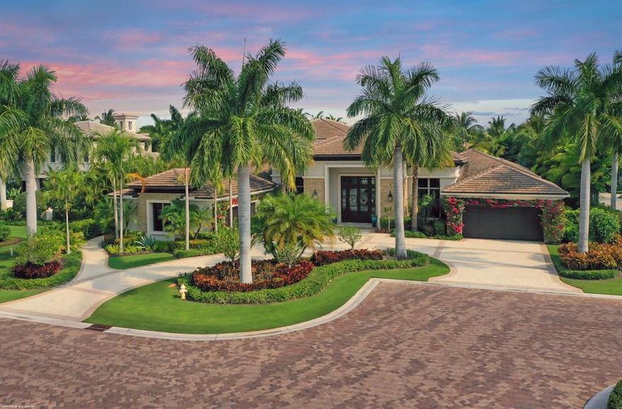 Gorgeous custom estate home in the Grand Estate neighborhood of Old Palm Golf Club.  This half acre residence is one to impress, showcasing a private water feature view, volume ceilings, wood & marble floors, a custom climate controlled wine wall that's sure to please any wine enthusiast; and split garages that encompass 4.5 car garage plus 2 lifts for a total accommodation of 6 1/2 car garage!  A luxurious master suite with spa-like master bathroom, His & Her spacious walk-in closets & a beautiful view of the pool & water feature.  This home features both formal and informal living and dining areas, a stunning light & bright gourmet kitchen w/top of the line appliances, back lit Quartz tops, built in coffee maker, butler pantry plus a large walk-in pantry, a handsome library/office, an incredible play room & loft, and its even prepped for future residential elevator.  The backyard is a tropical oasis boasting a summer kitchen w/built in BBQ, refrigerator, dishwasher, covered lanai w/motorized screens and built in TV, custom heated pool with rock water feature and slide.  This is the perfect home for entertaining!  Other features include synthetic turf, reverse osmosis water system, whole house generator, motorized shades, hard wood floors, and an over sized laundry room with lots of windows.